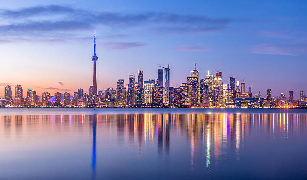 Toronto skyline at dusk with CN Tower overlooking Lake Ontario — payment processing, Interac and Clover POS systems for Canadian businesses from Merchant Solutions Corp