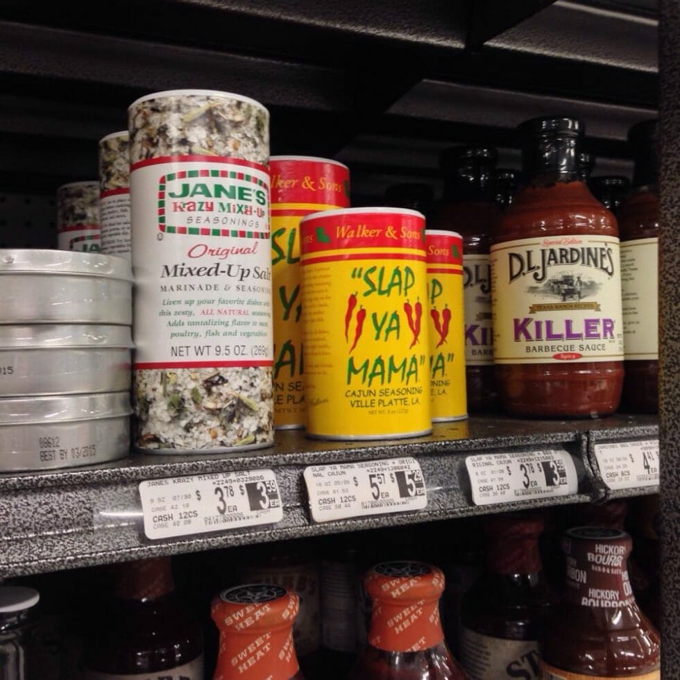 Retail store shelf with dual pricing labels showing cash and card prices