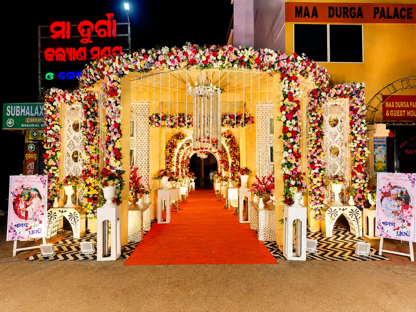 Maa Durga Palace signature outdoor entrance with lit floral archway and red carpet