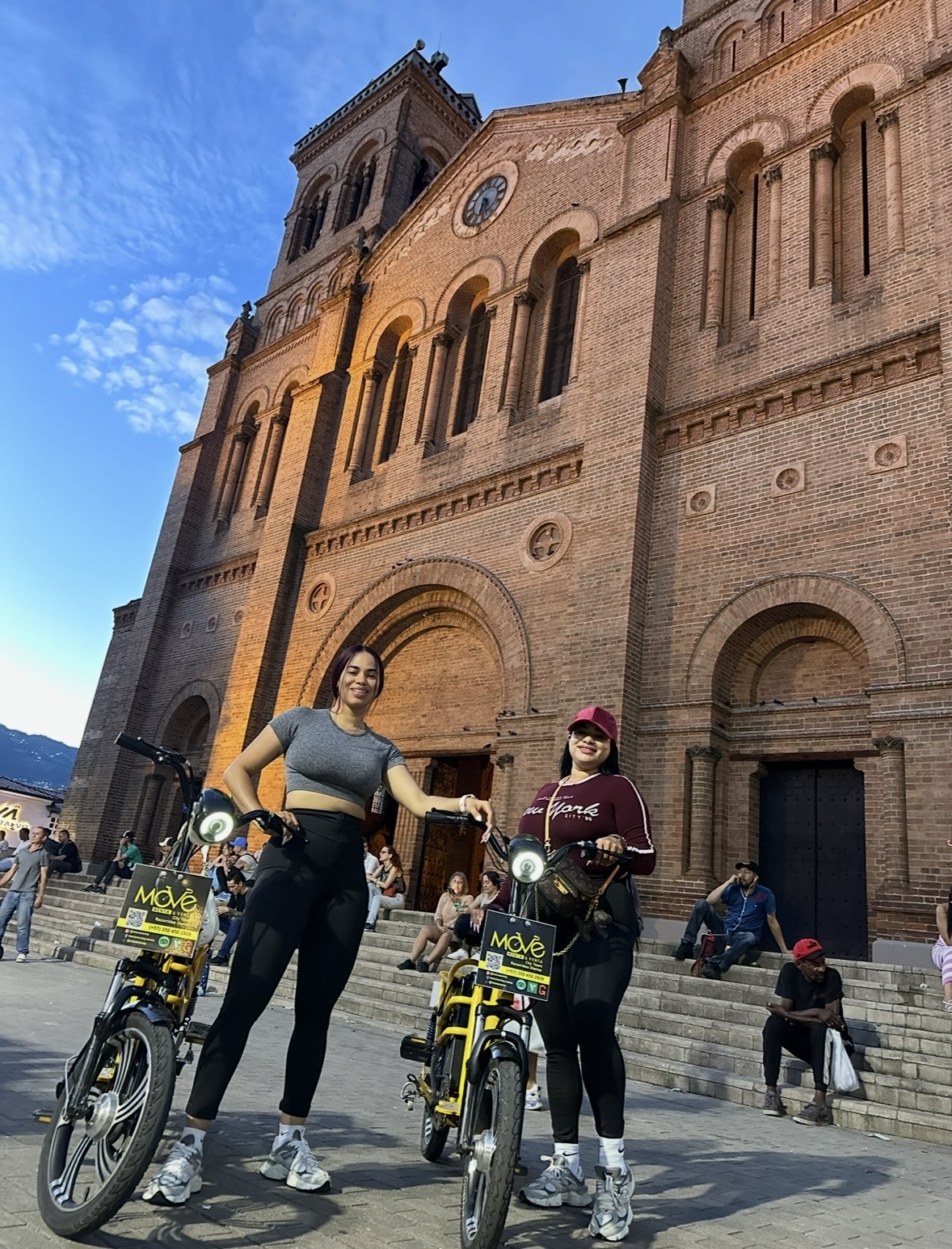 MOVE electric bikes in front of a downtown Medellín church
