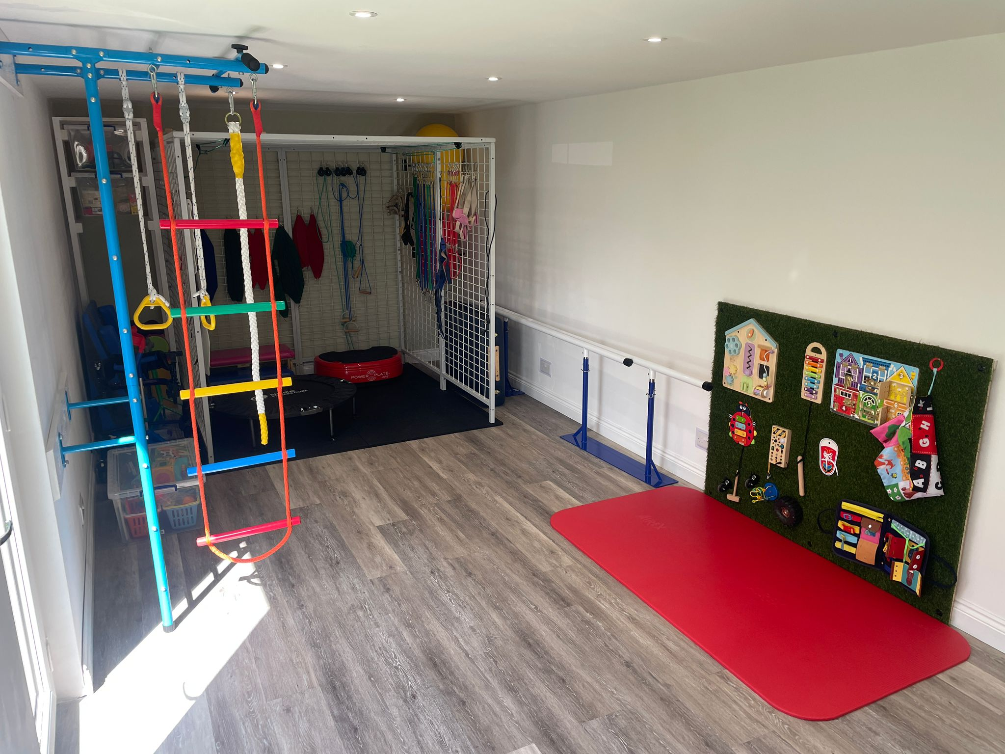 Inside the Growing Together Physio paediatric studio in Sandy — spider cage frame, climbing ladder, trampoline and sensory equipment for child physiotherapy sessions