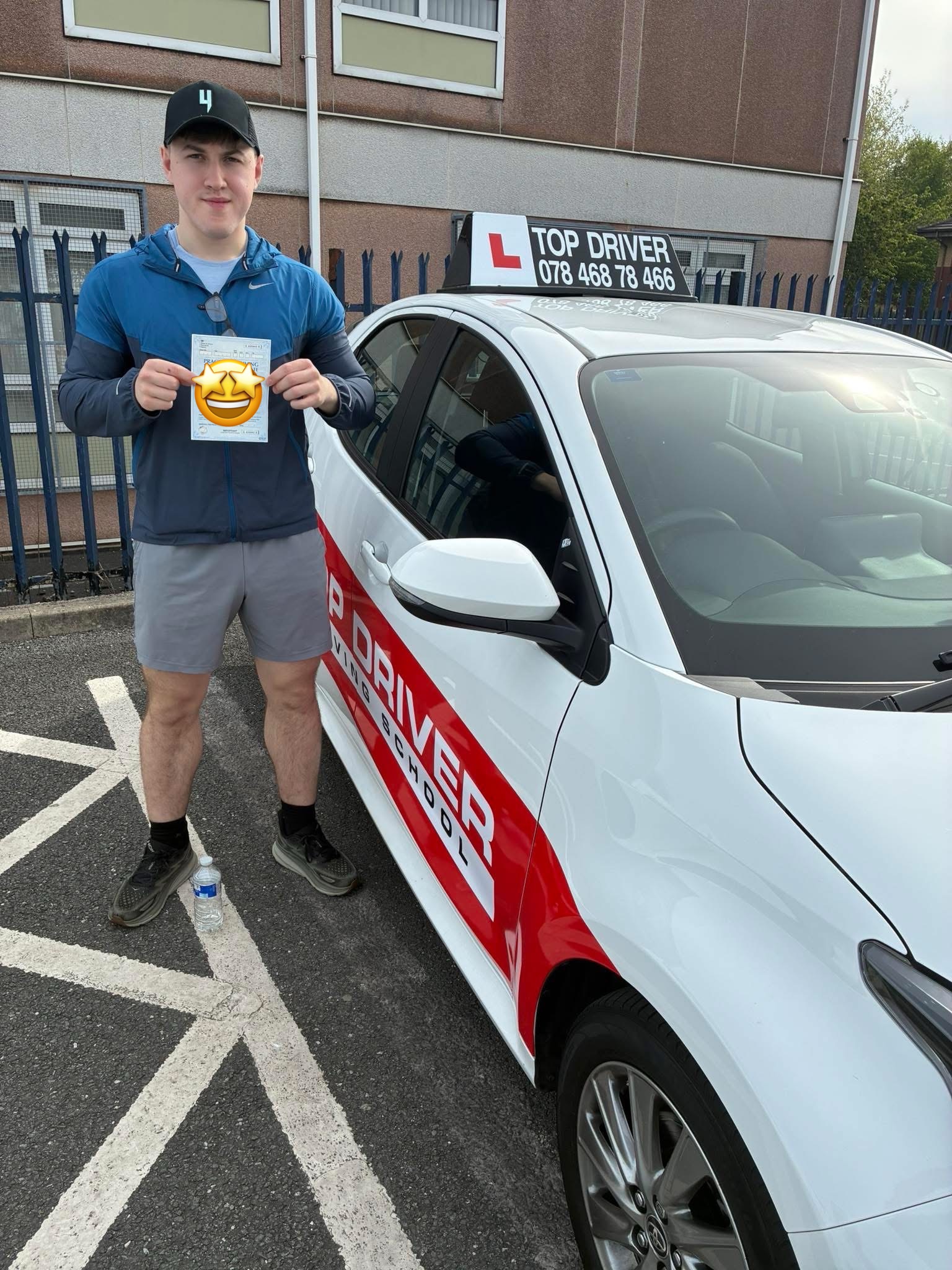 Male student celebrating pass with Top Driver