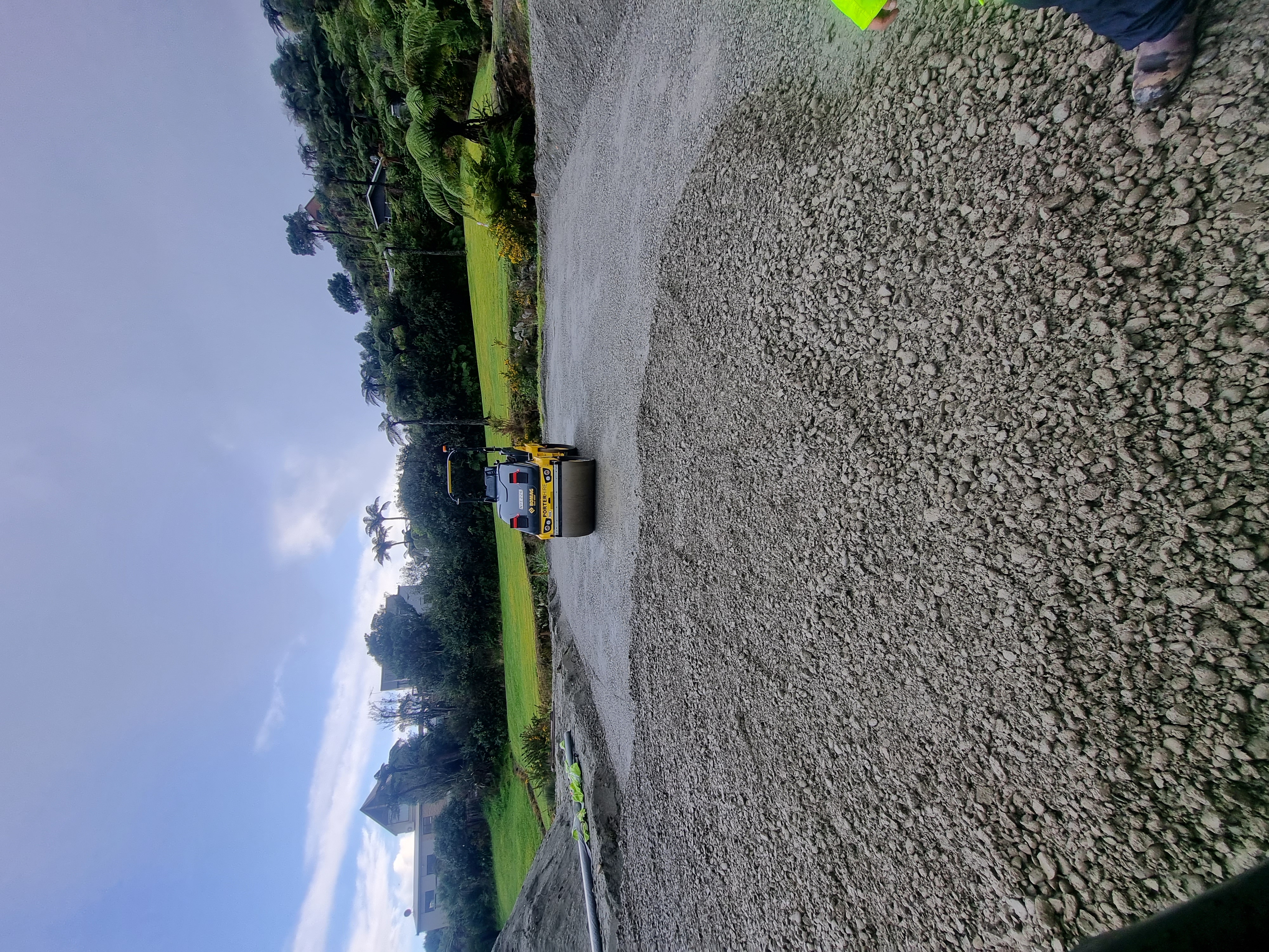 Roller compactor finishing a building pad during site preparation, Hokitika