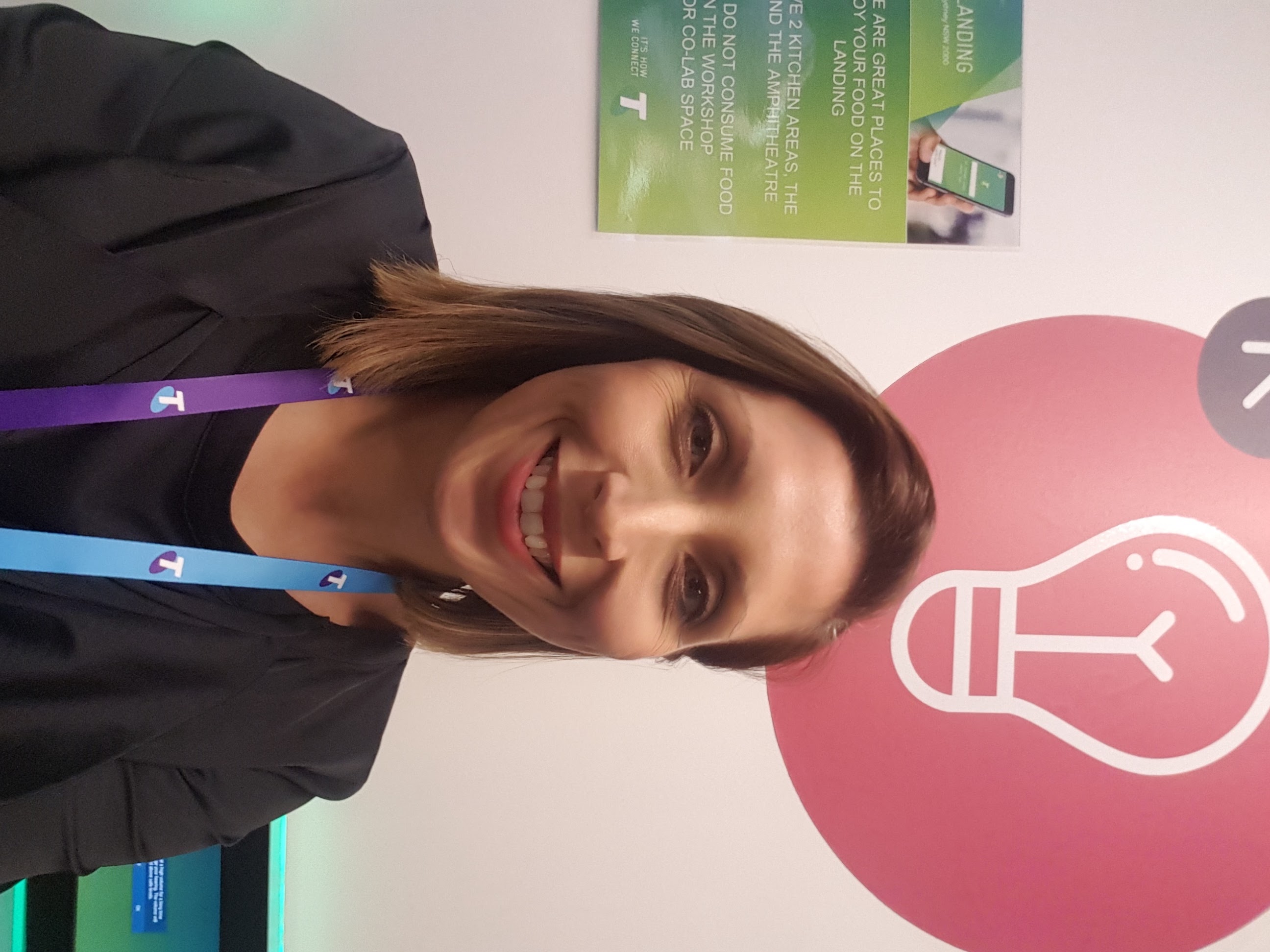 Louise at Telstra Customer Innovation Centre with Telstra lanyards