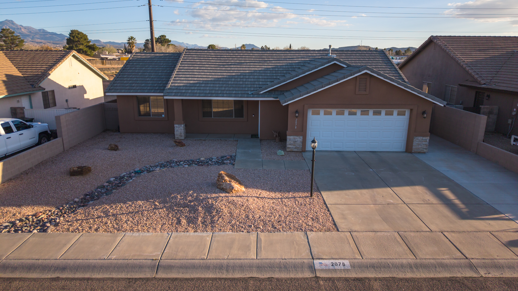 Aerial view of residential property with mountain backdrop