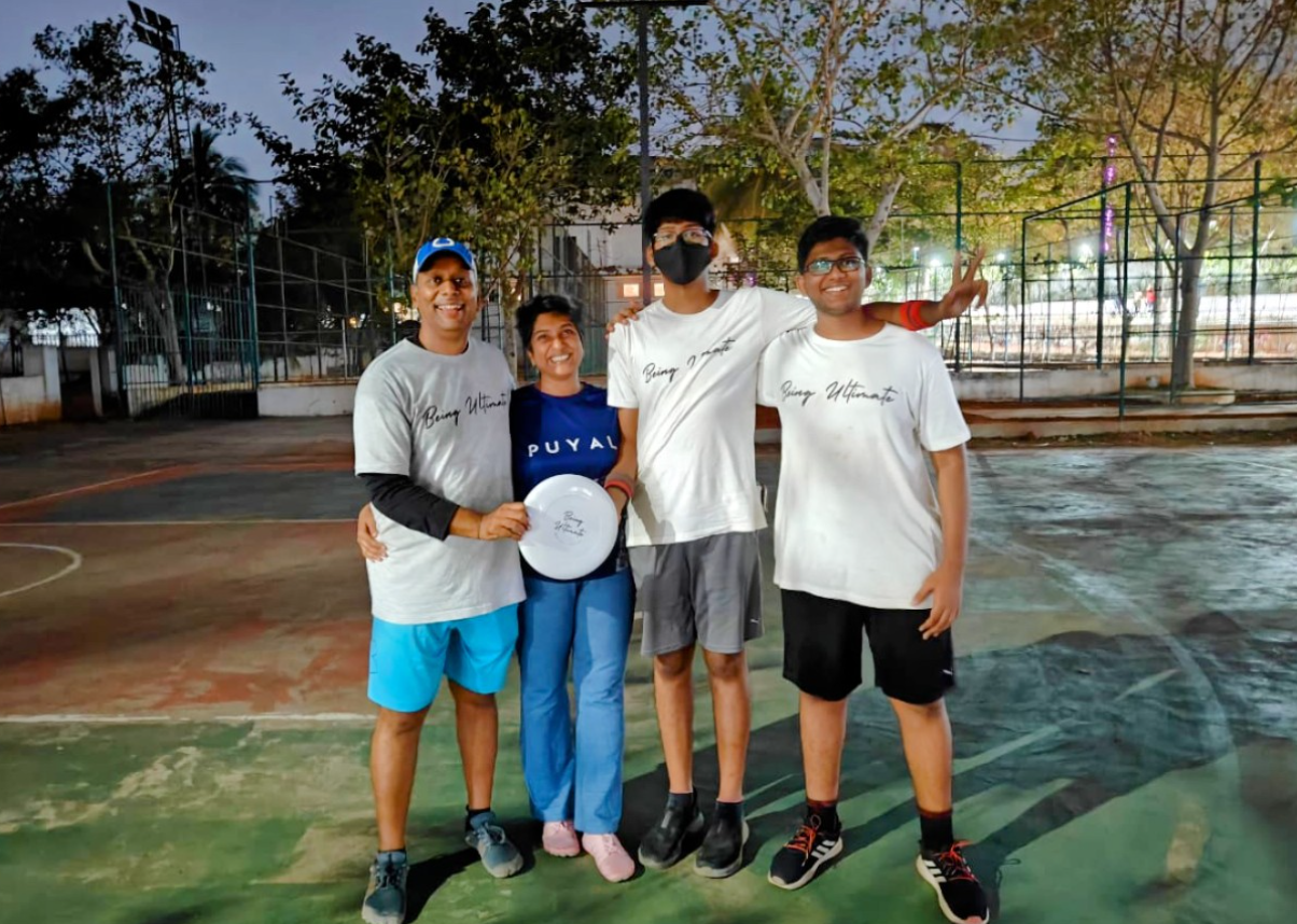 The Being Ultimate founding family on a court, holding a disc