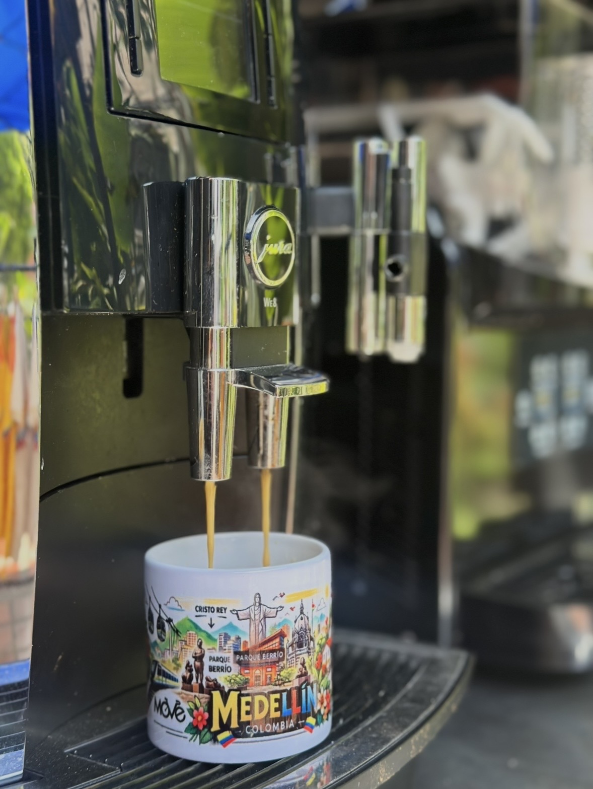 Bolsa Medellín Coffee Company junto a máquina Jura