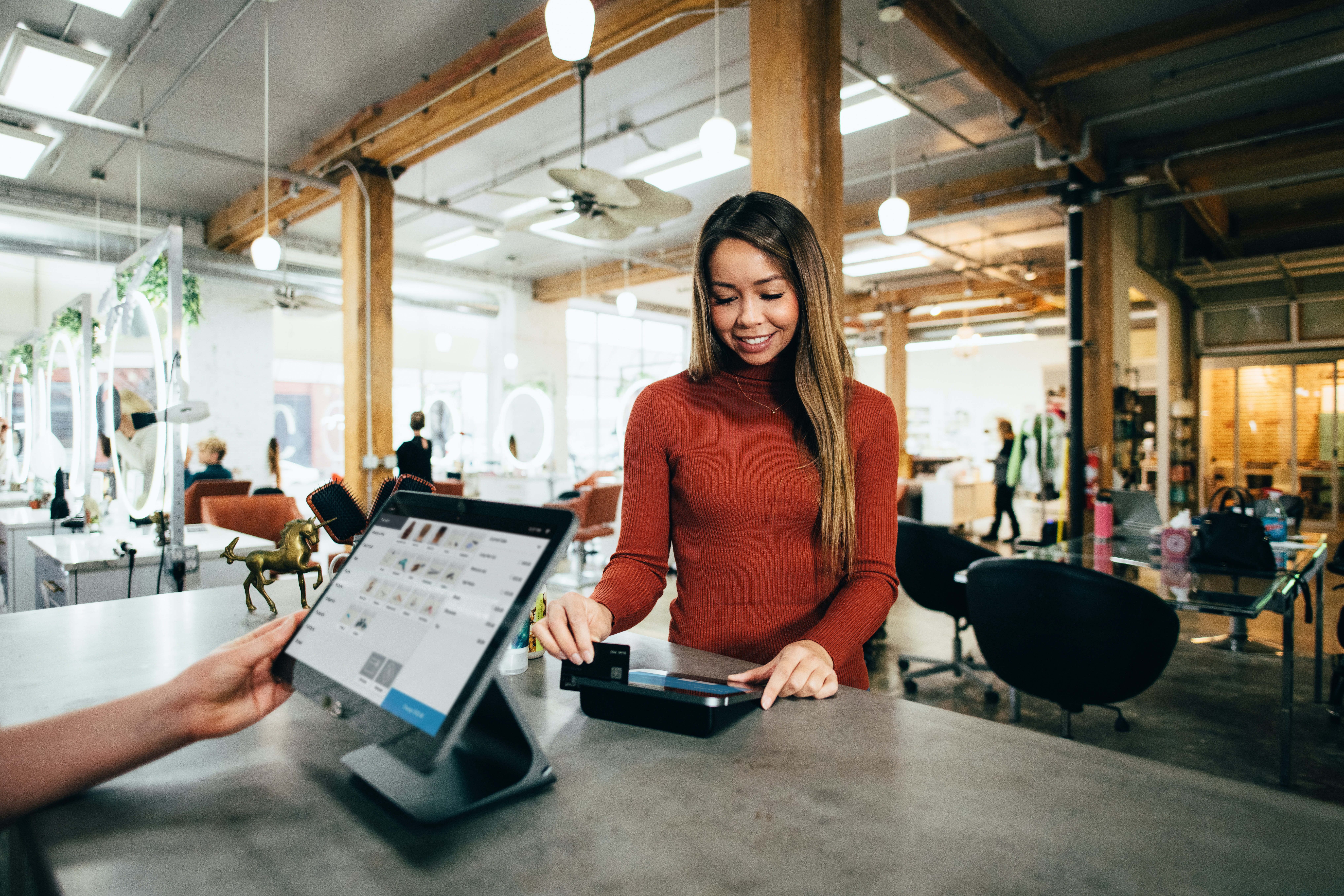 Customer making a payment at a restaurant POS terminal