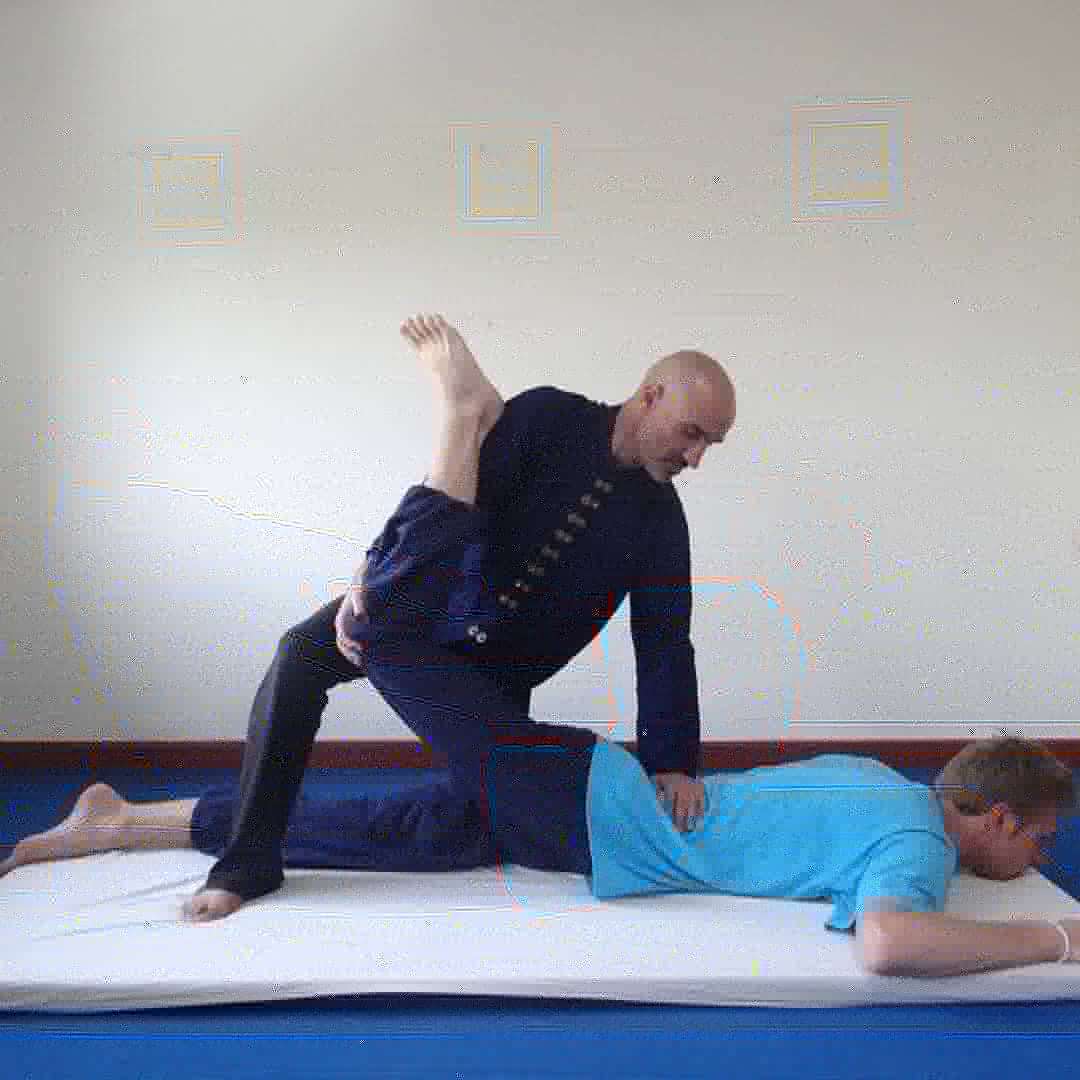 Rino performing a traditional Thai massage stretch