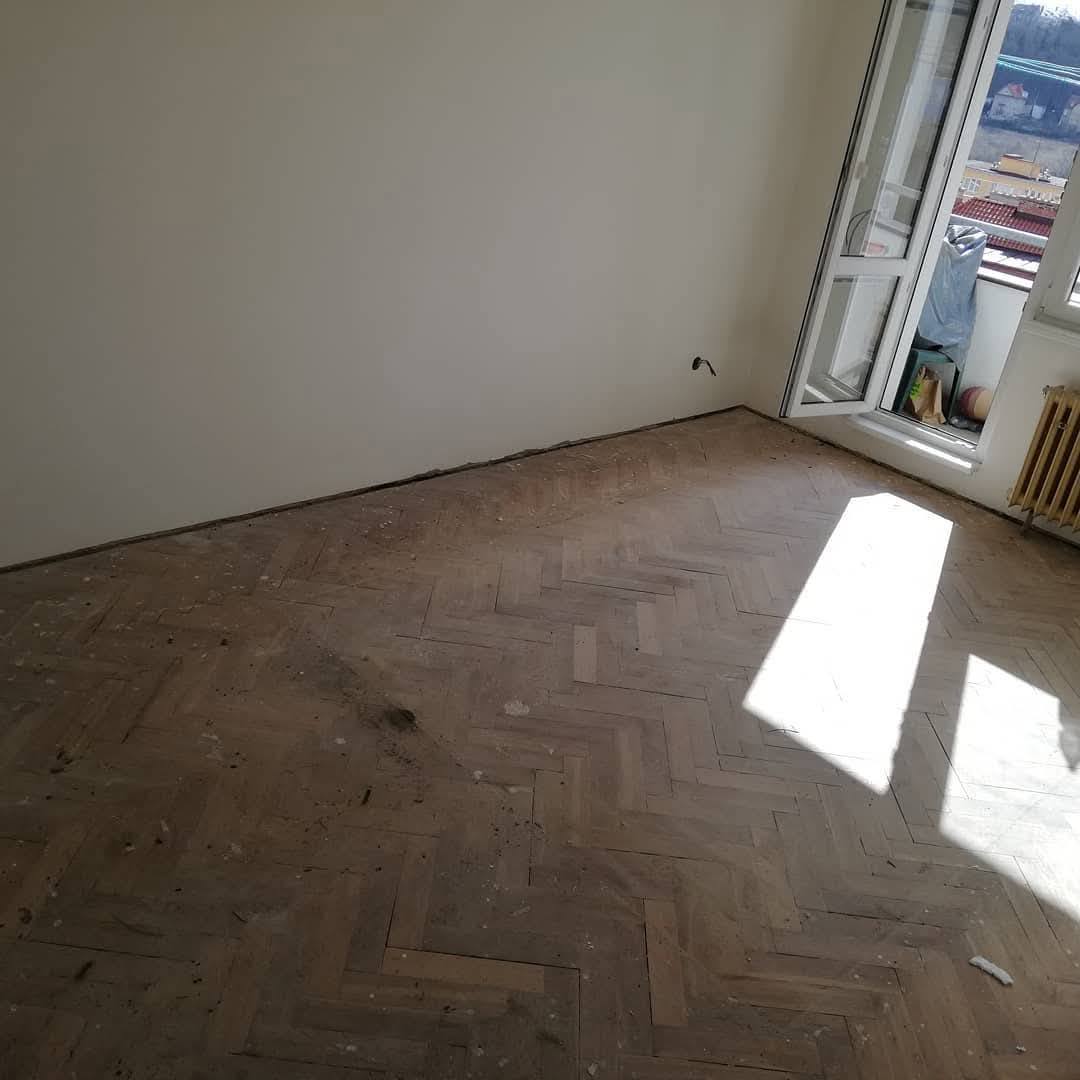 Dirty and damaged herringbone parquet floor before restoration