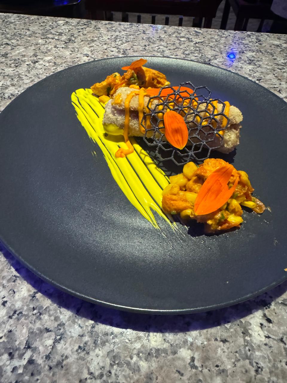 Plated dish with honeycomb tuile garnish