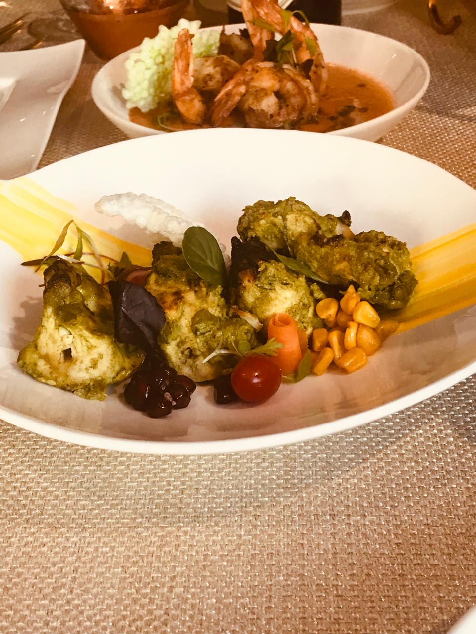 Hariyali tikka skewer with biryani and mint raita