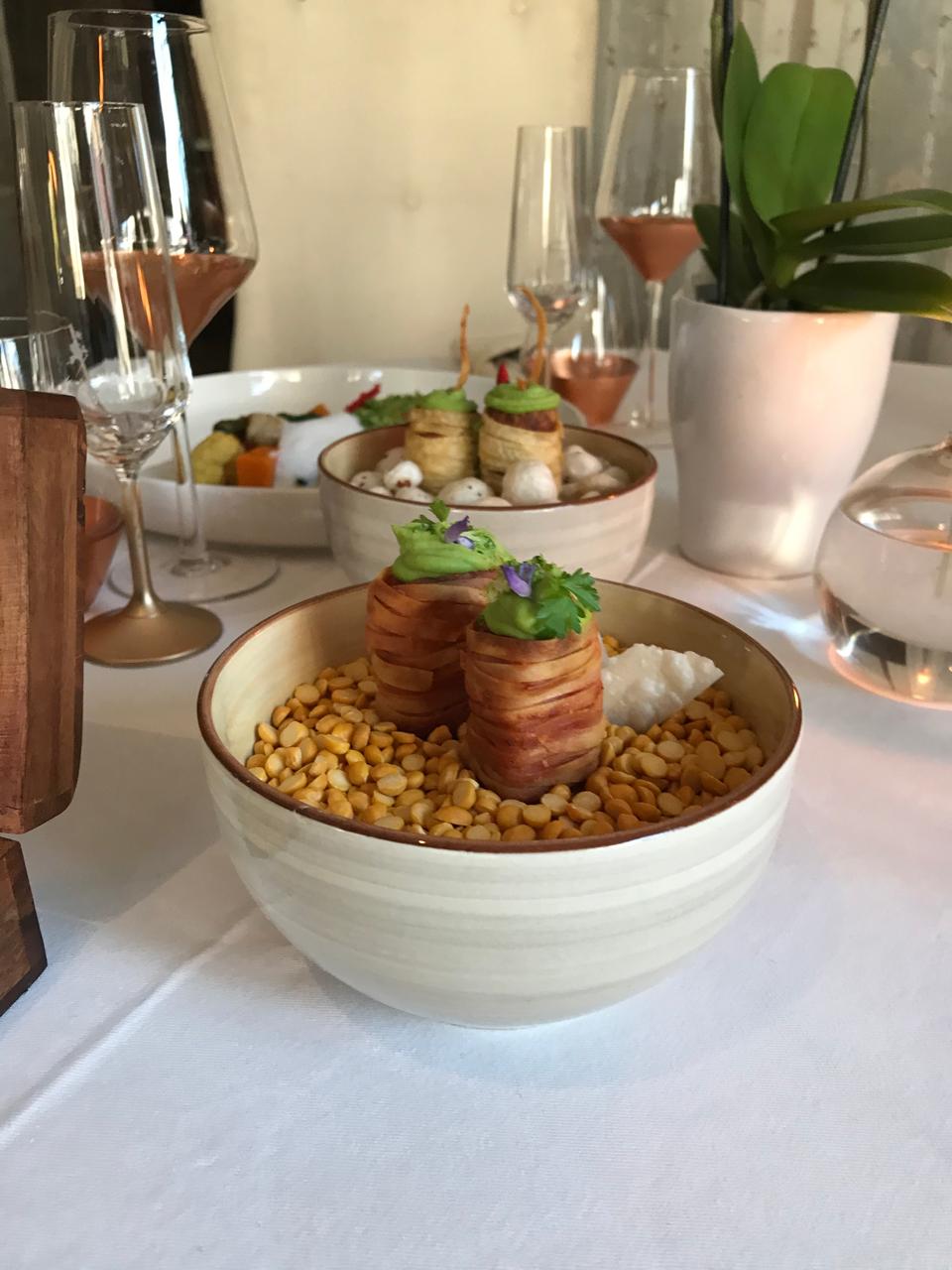 Wrapped kebabs over yellow lentils
