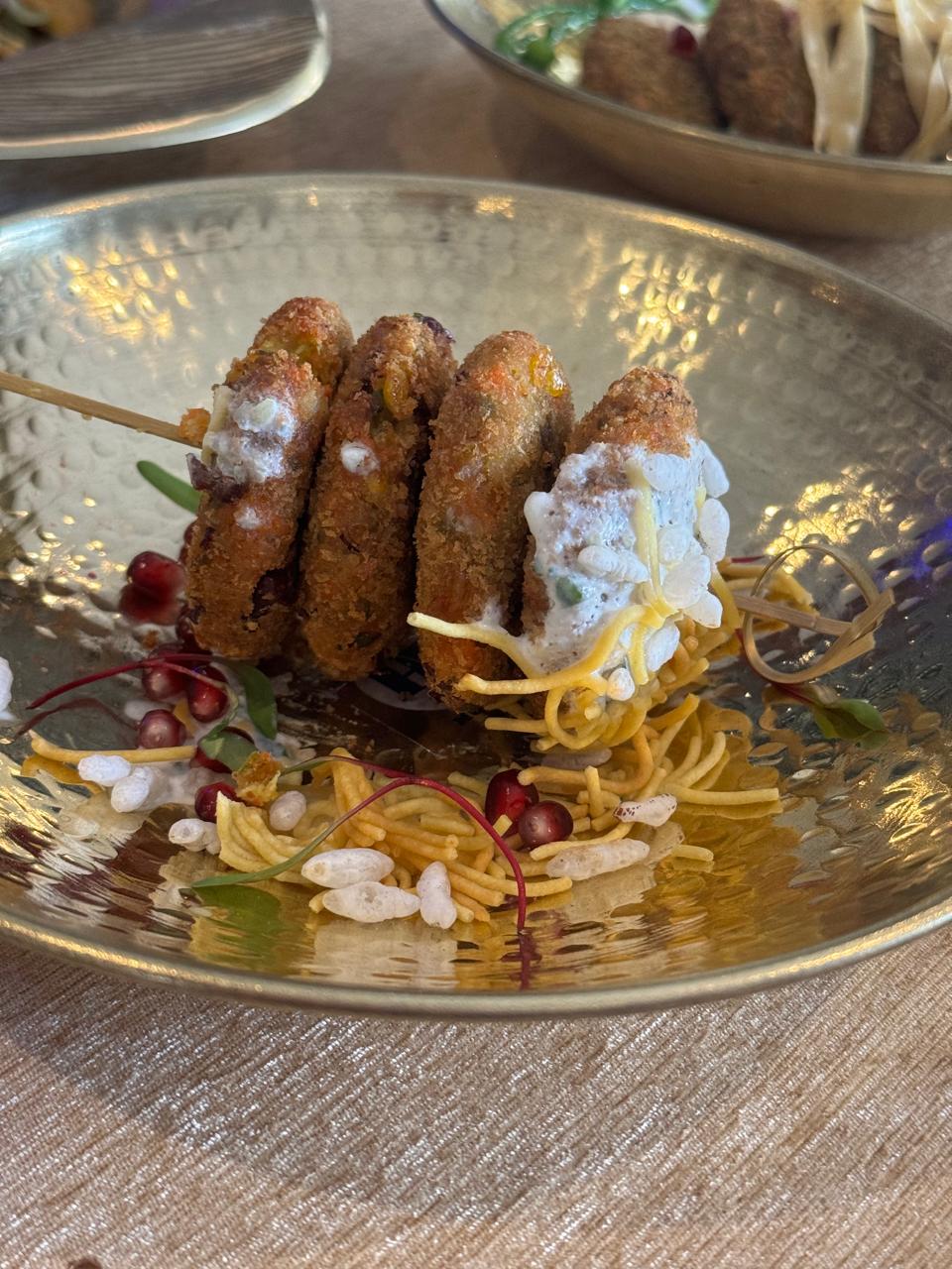 Crusted kebab skewer with sev and curd