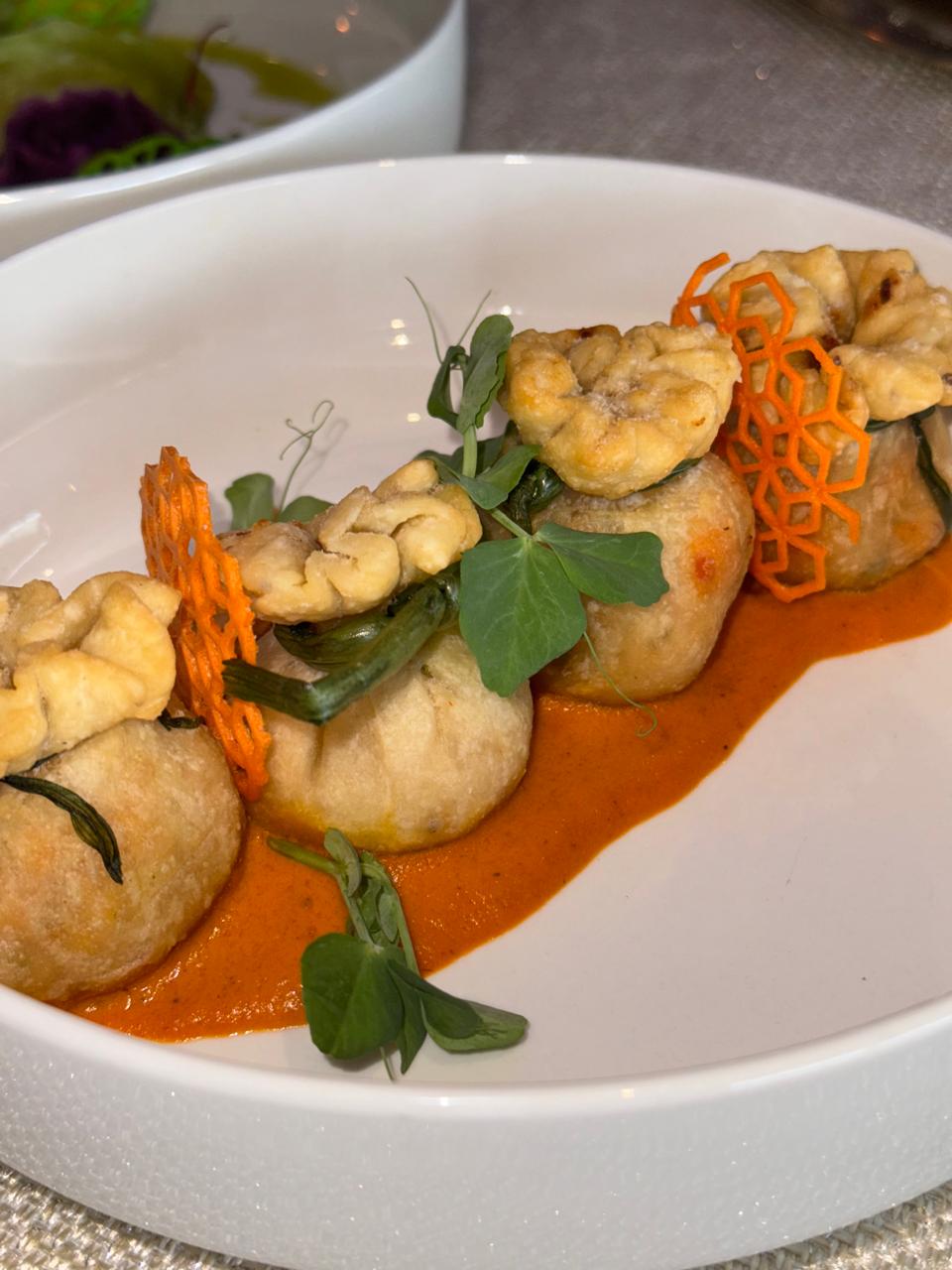 Potli kebabs with carrot tuile in red gravy