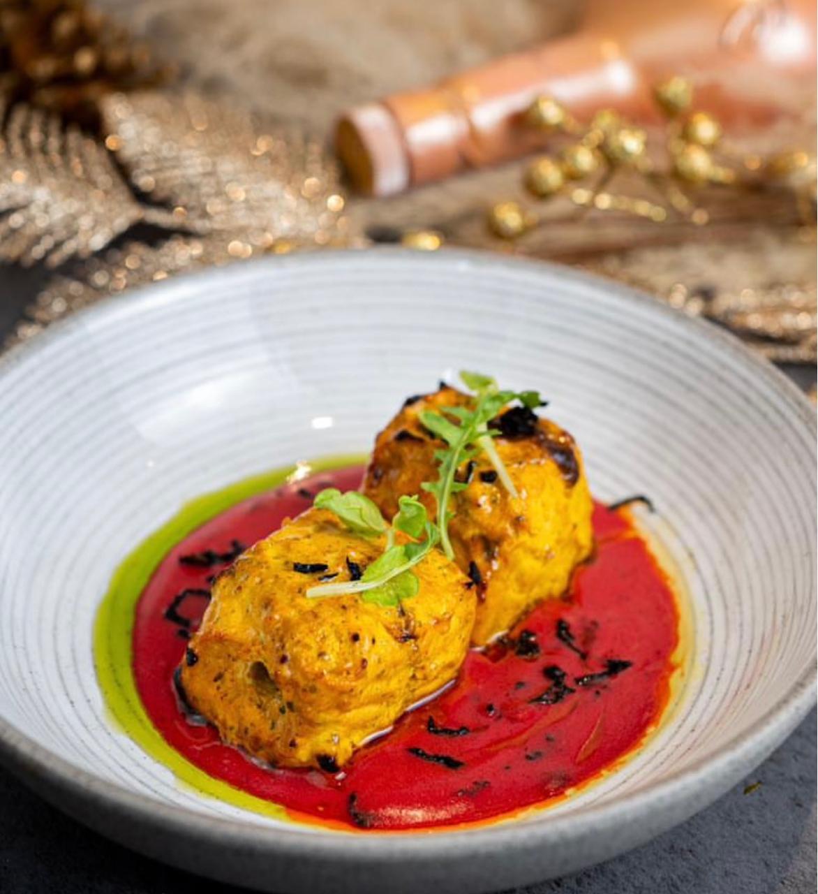 Saffron tikka in red sauce with chive oil