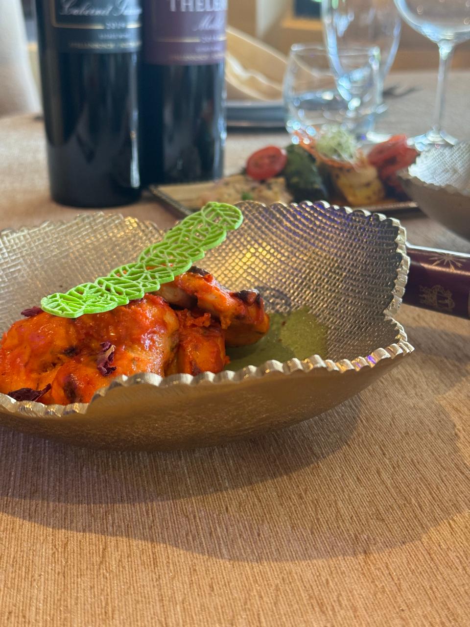 Tandoori chicken on golden scalloped dish