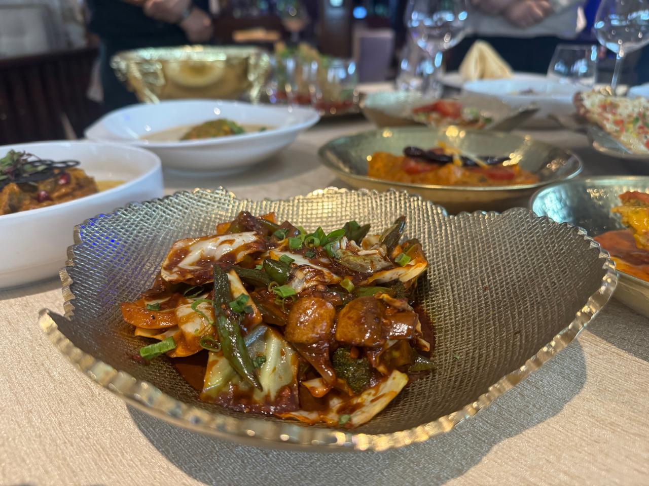 Indo-Chinese vegetable stir-fry in scalloped silver bowl