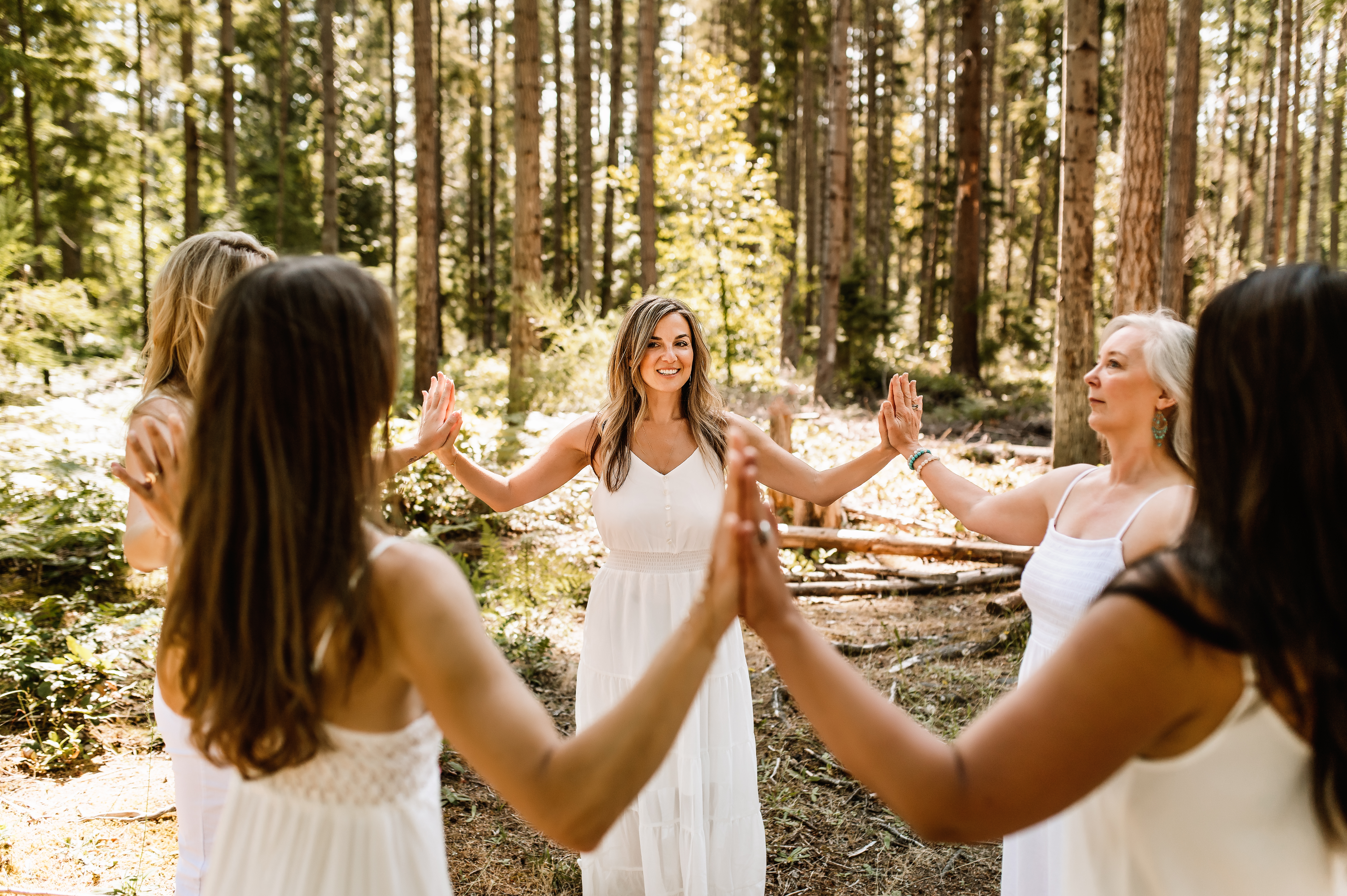 J leading a circle of women in the forest