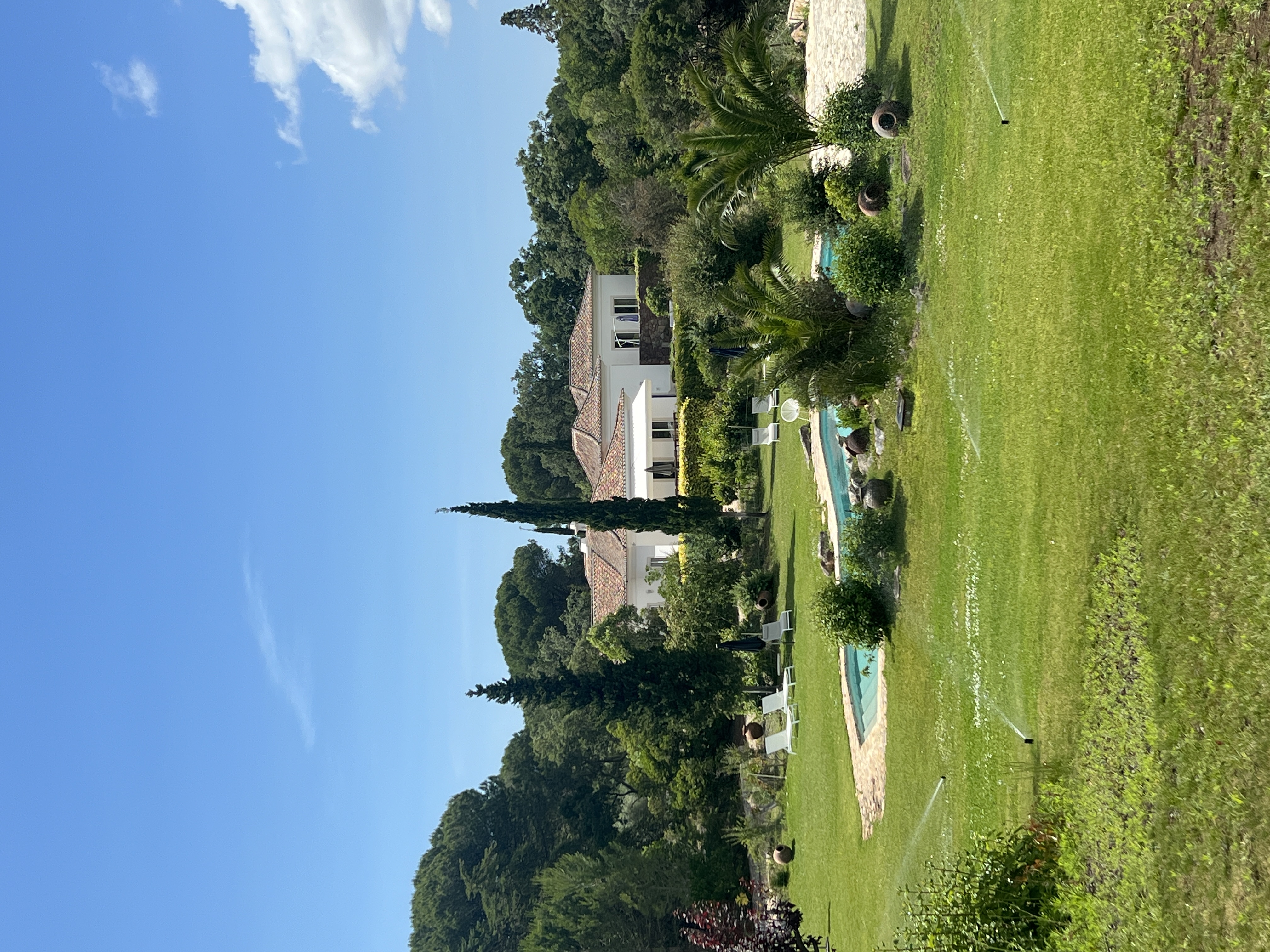 Manor house exterior with pool and lawn