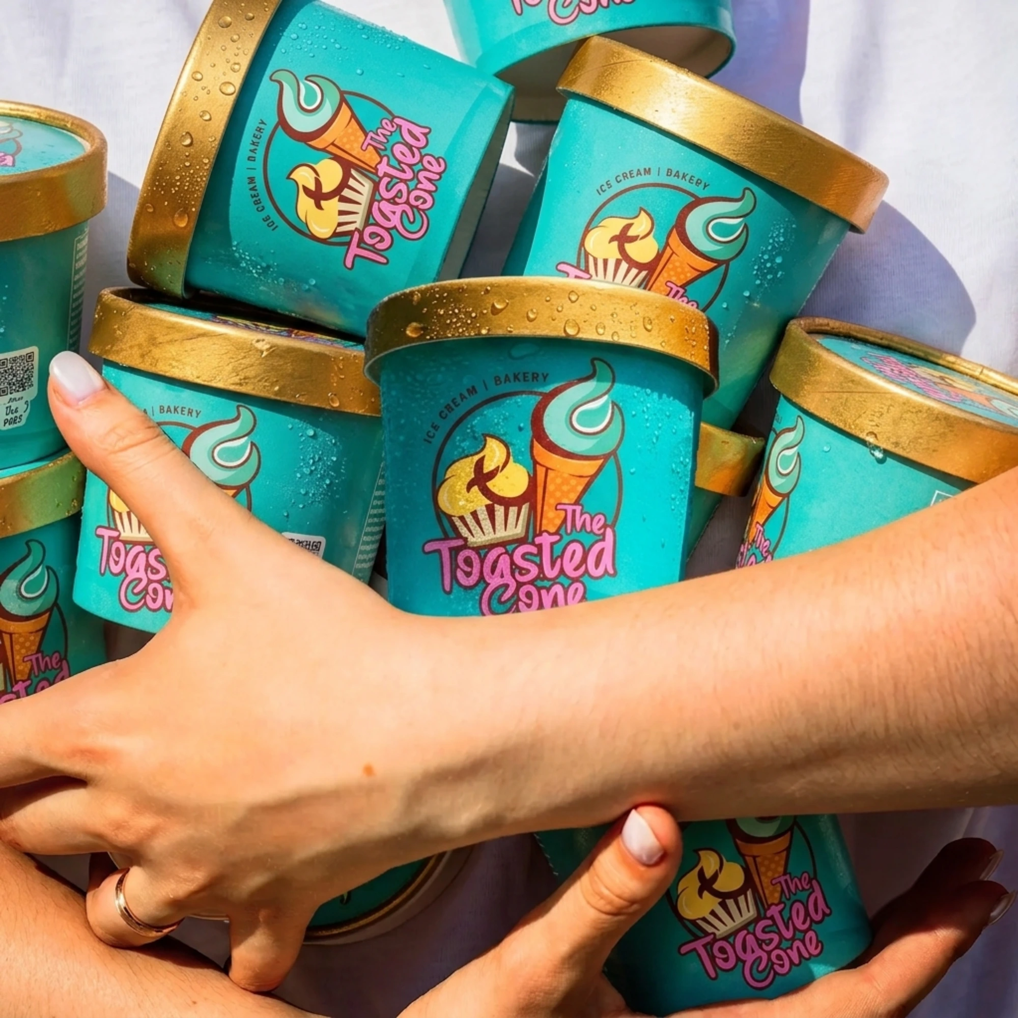 Armful of Toasted Cone ice cream pints