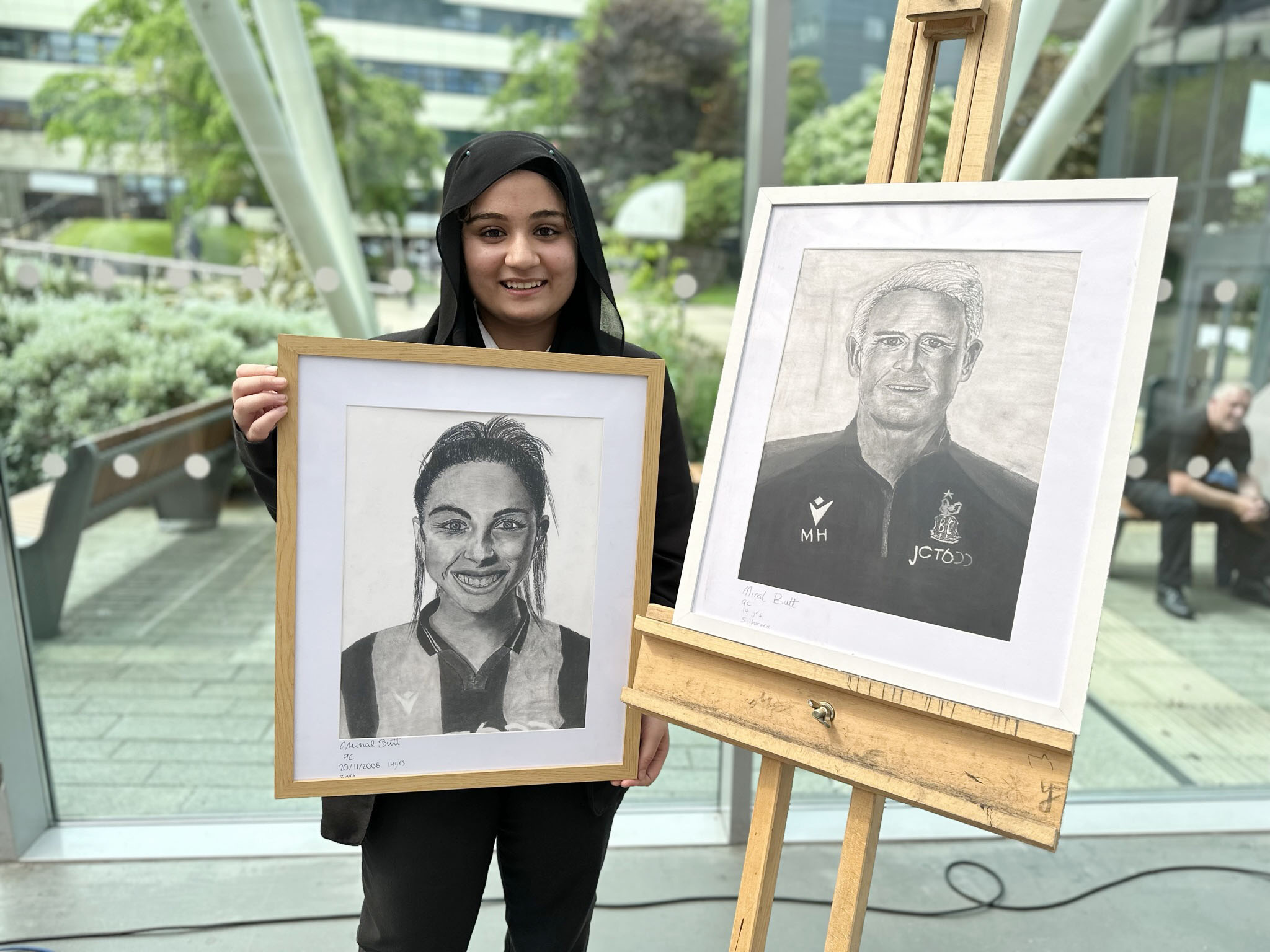 Student with charcoal portraits
