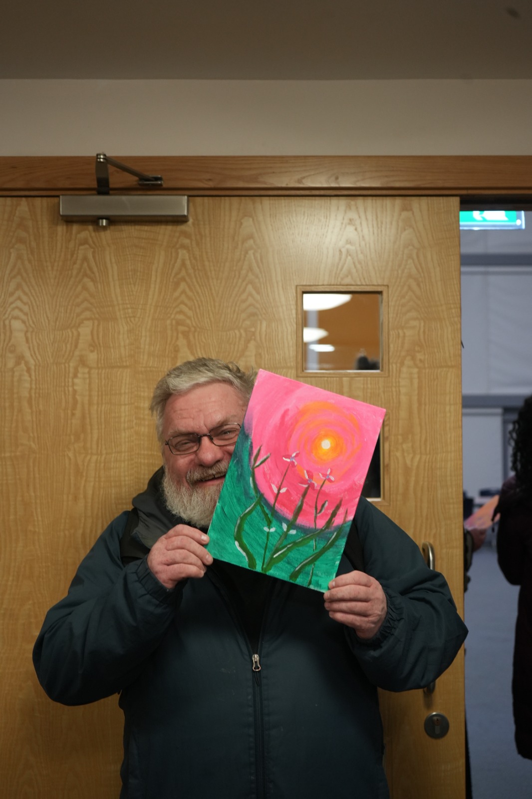 Participant with vibrant pink sunset painting