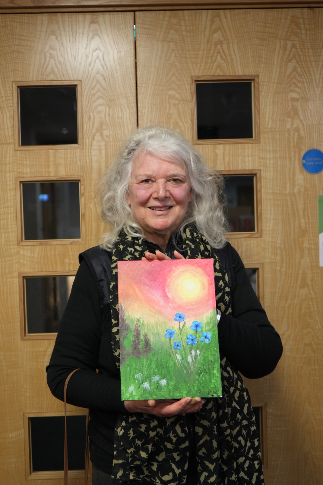 Participant with sunset meadow painting