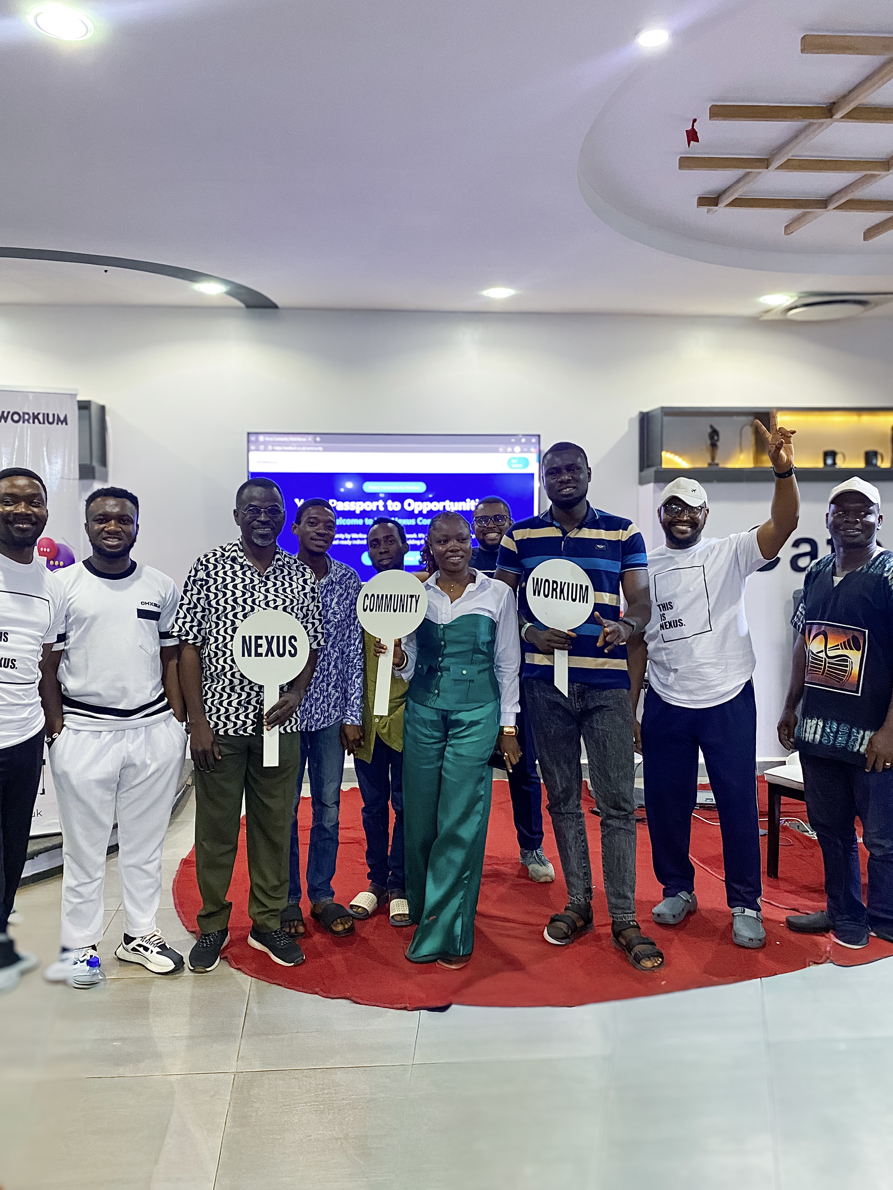 Nexus Ibadan members holding Workium, Nexus and Community signs
