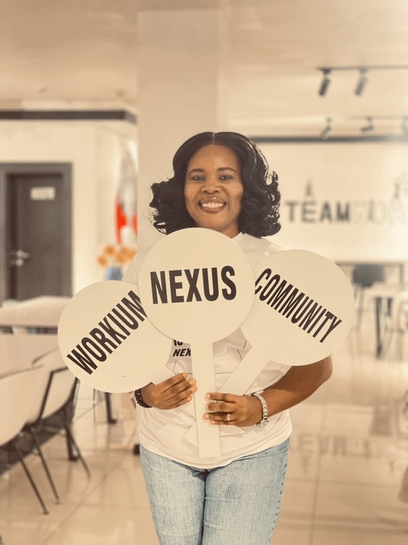 Nexus Community member holding Workium · Nexus · Community signs