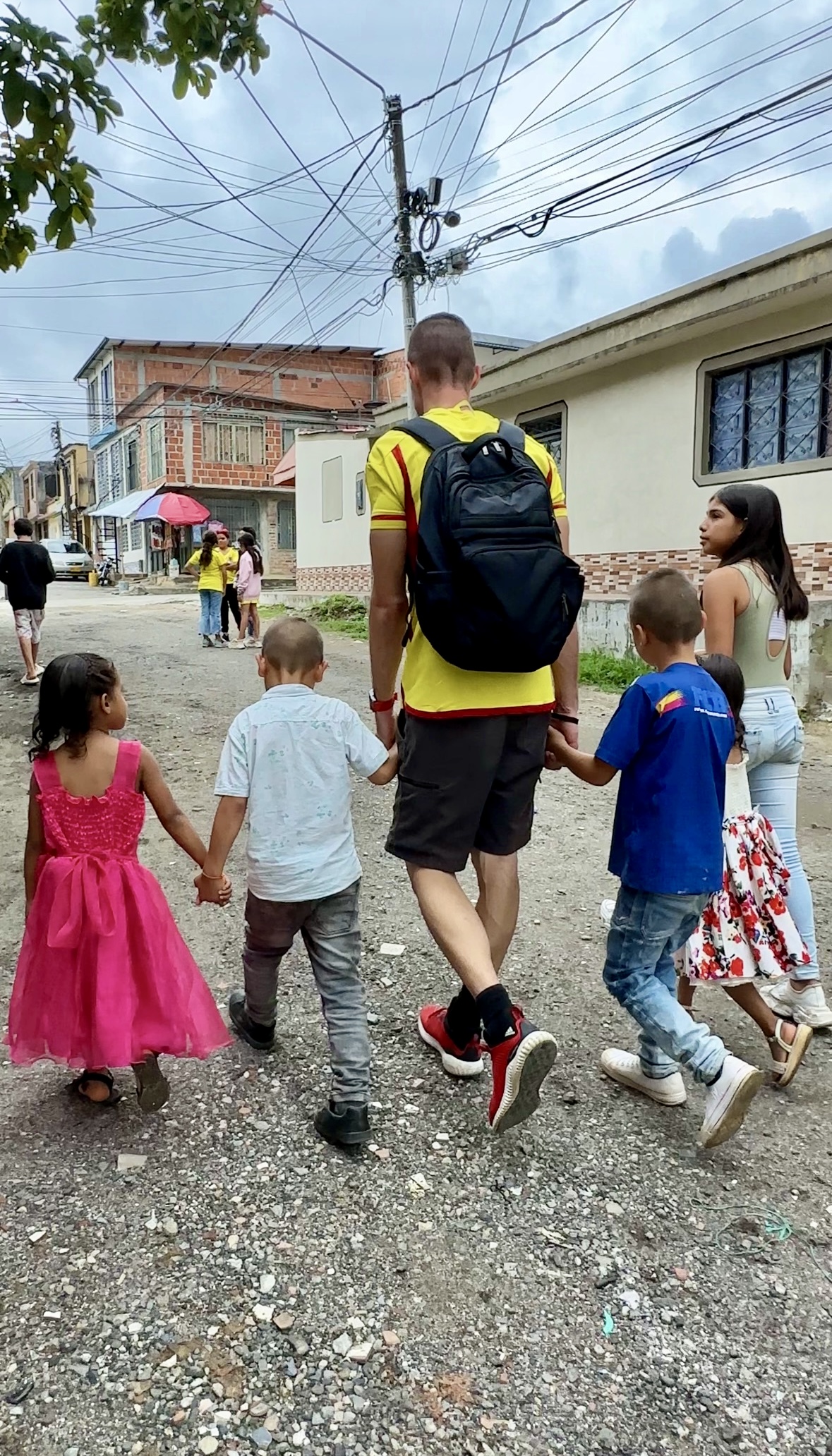 Angelo walking with children in Colombia