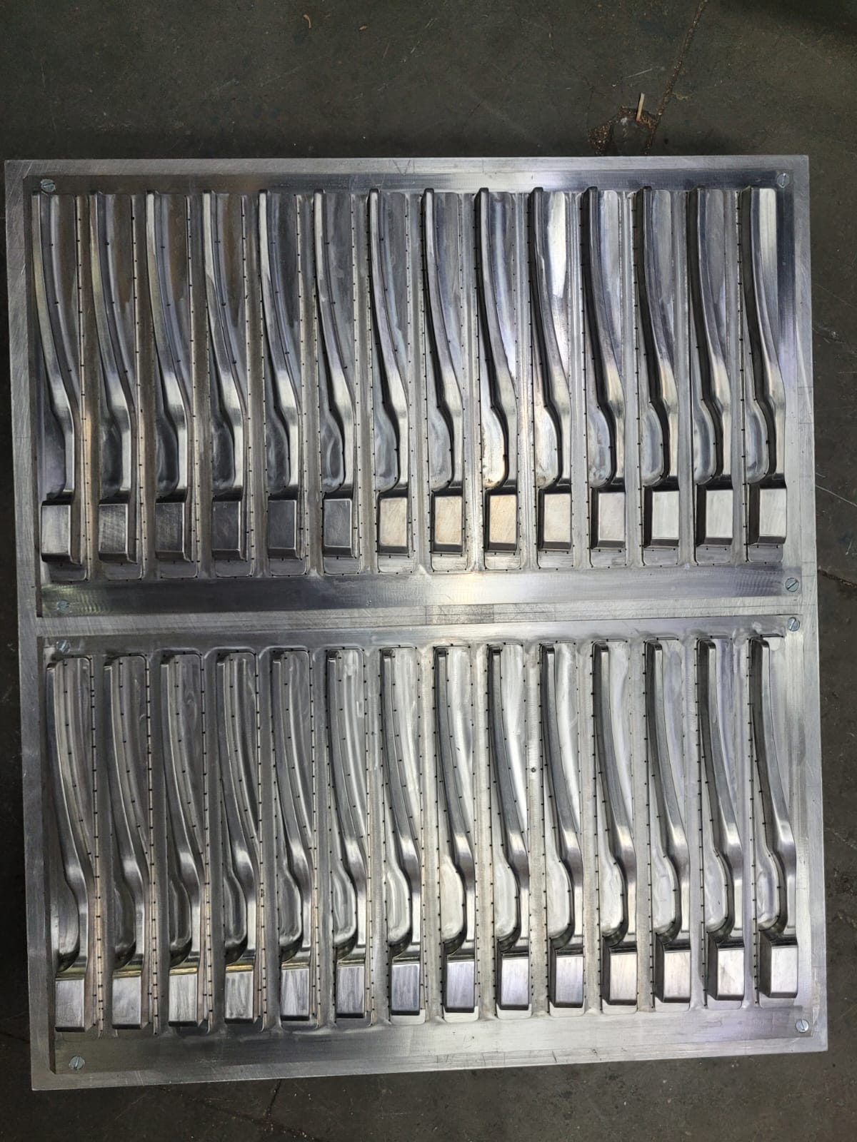 Row of precision machined die cavities for vacuum forming