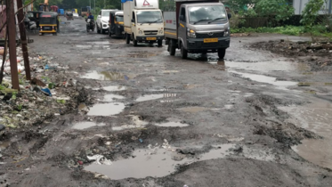 Damaged broken road surface with potholes