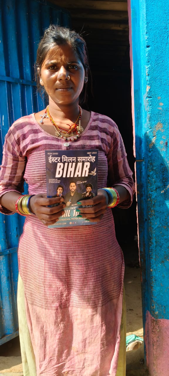 Bihar community member holding revival invitation flyer 1
