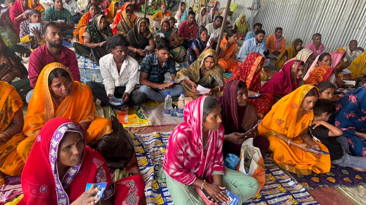 Bihar community member holding revival invitation flyer 5