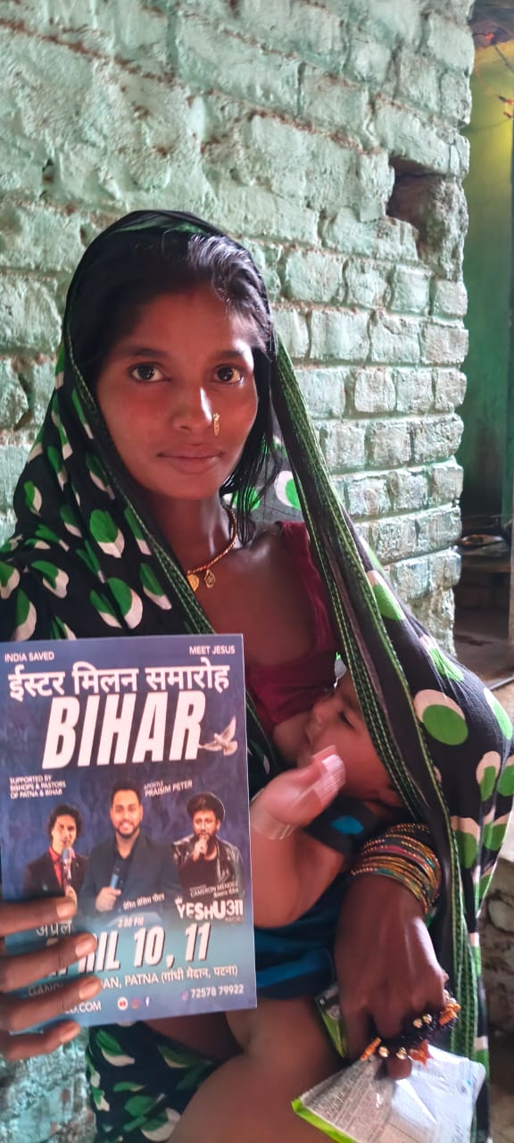 Bihar community member holding revival invitation flyer 2