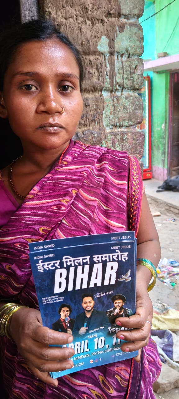Bihar community member holding revival invitation flyer 3