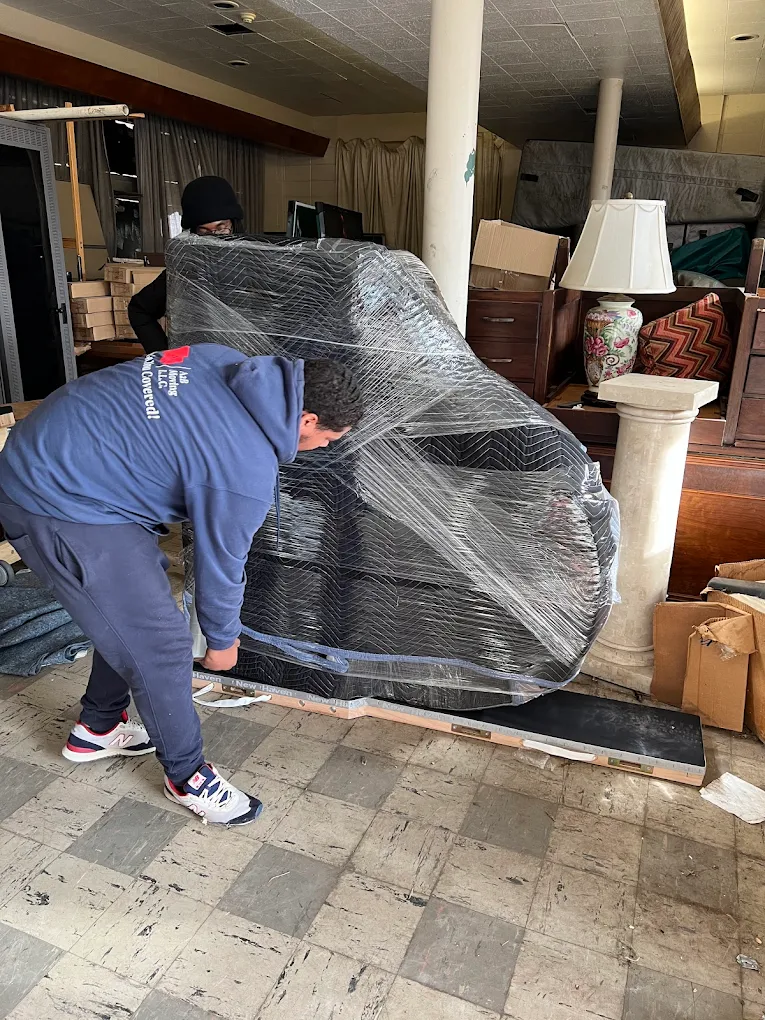 A2B movers carefully wrapping a large item