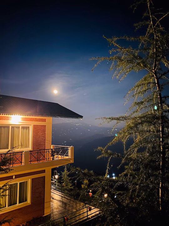Banpravas — a full moon rises over the valley, lights of distant villages below
