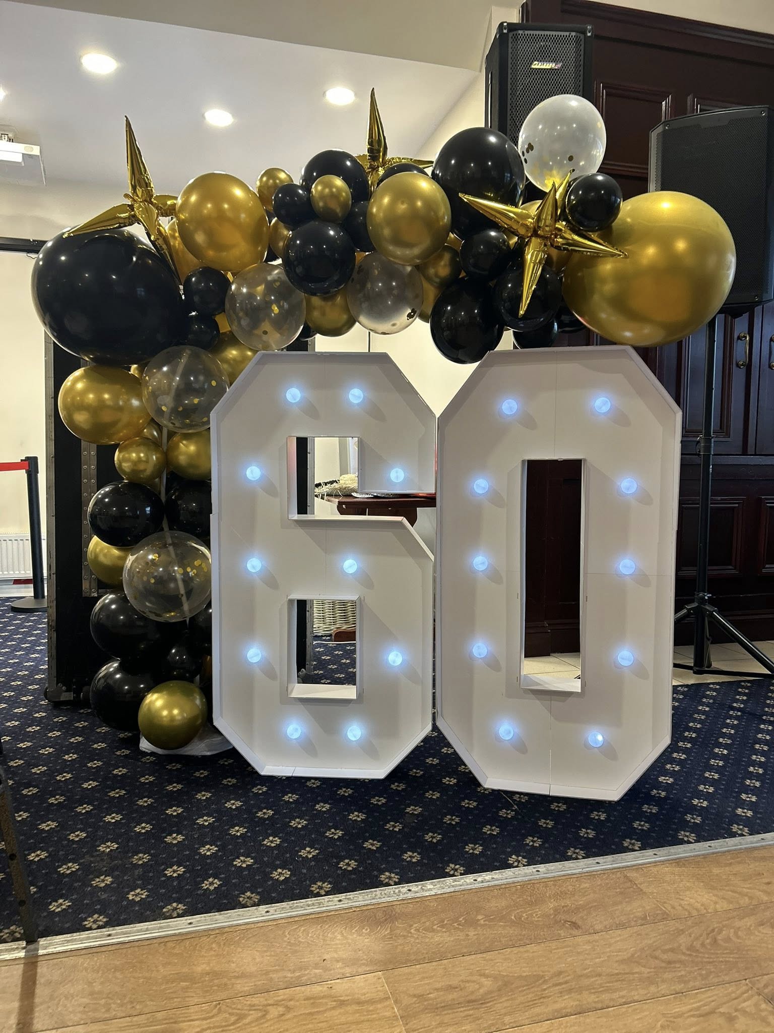Light-up 60 with black & gold balloon garland