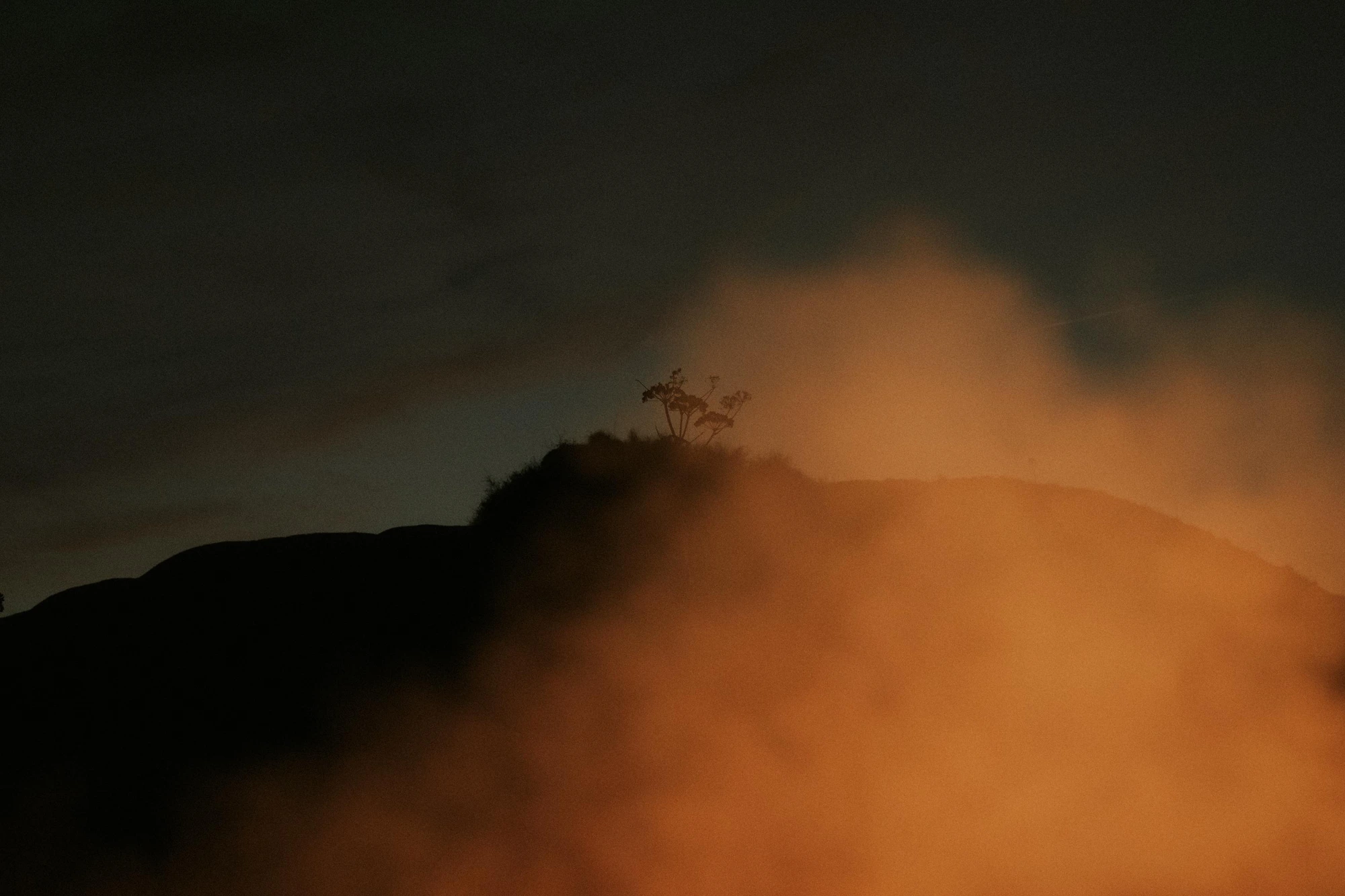 The Calanchi at night, veiled in amber haze