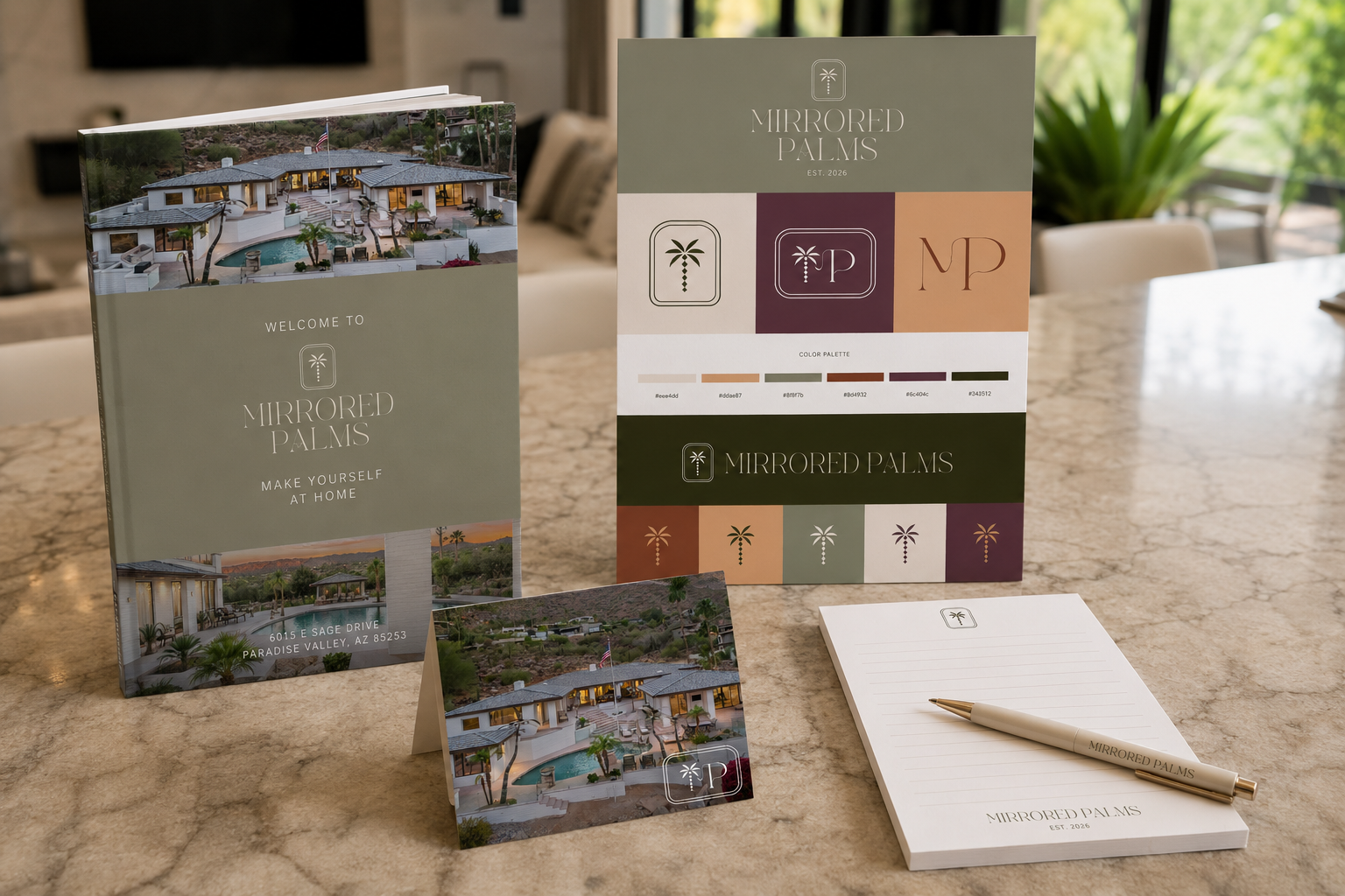 Mirrored Palms — full brand collateral in-situ: housebook, brand board, thank-you card and notepad on marble counter