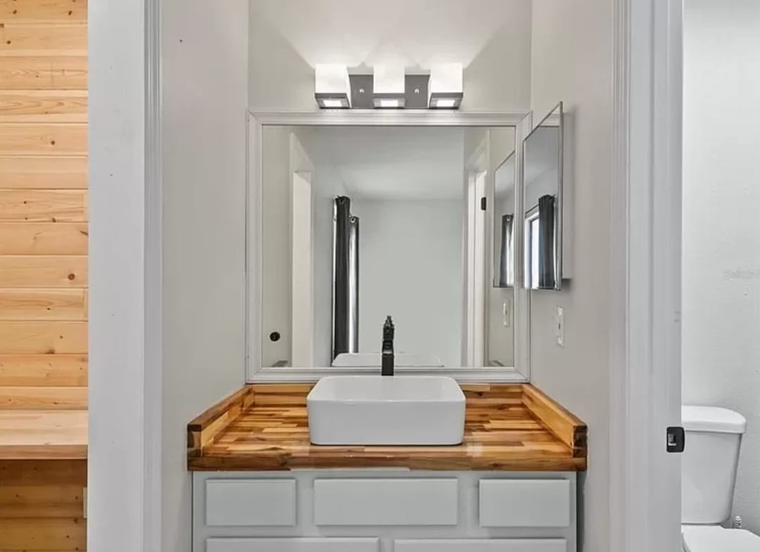 Powder room with wood countertop