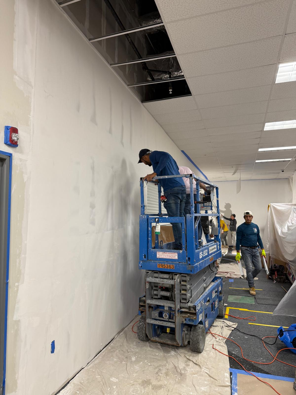 Wall finishing on scissor lift