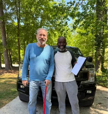 Victor Appiah with a neighbor during a District 5 signature drive
