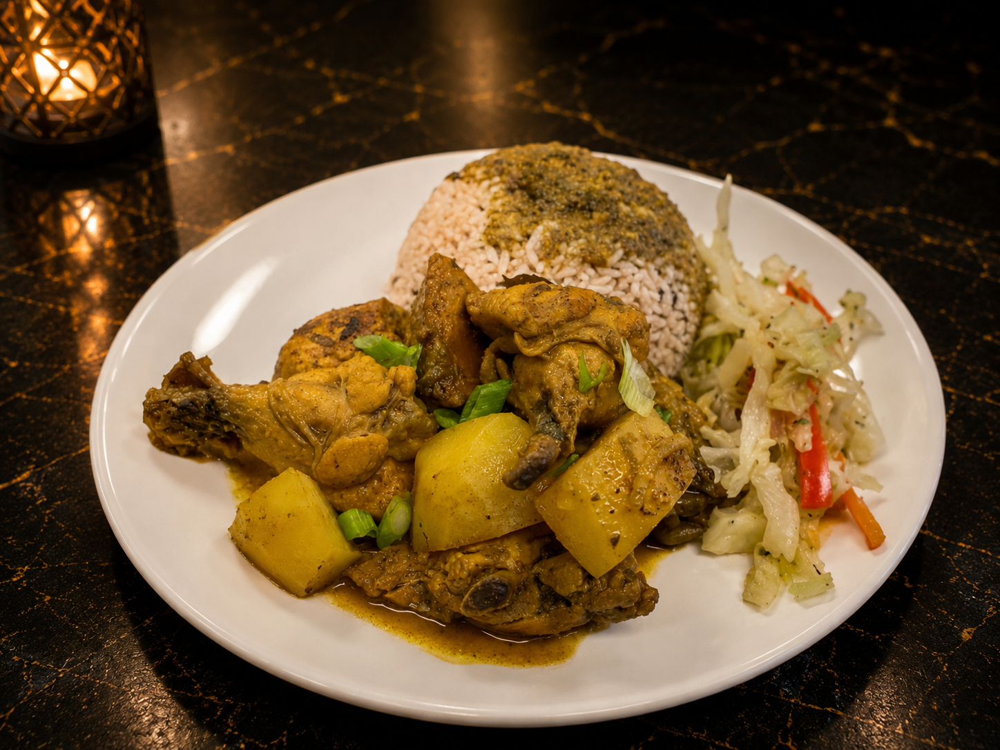 Curry Chicken — Authentic Jamaican curry chicken, slow-simmered with island spices and tender potatoes. Served with gungo peas & rice and steamed cabbage for a true Caribbean classic.