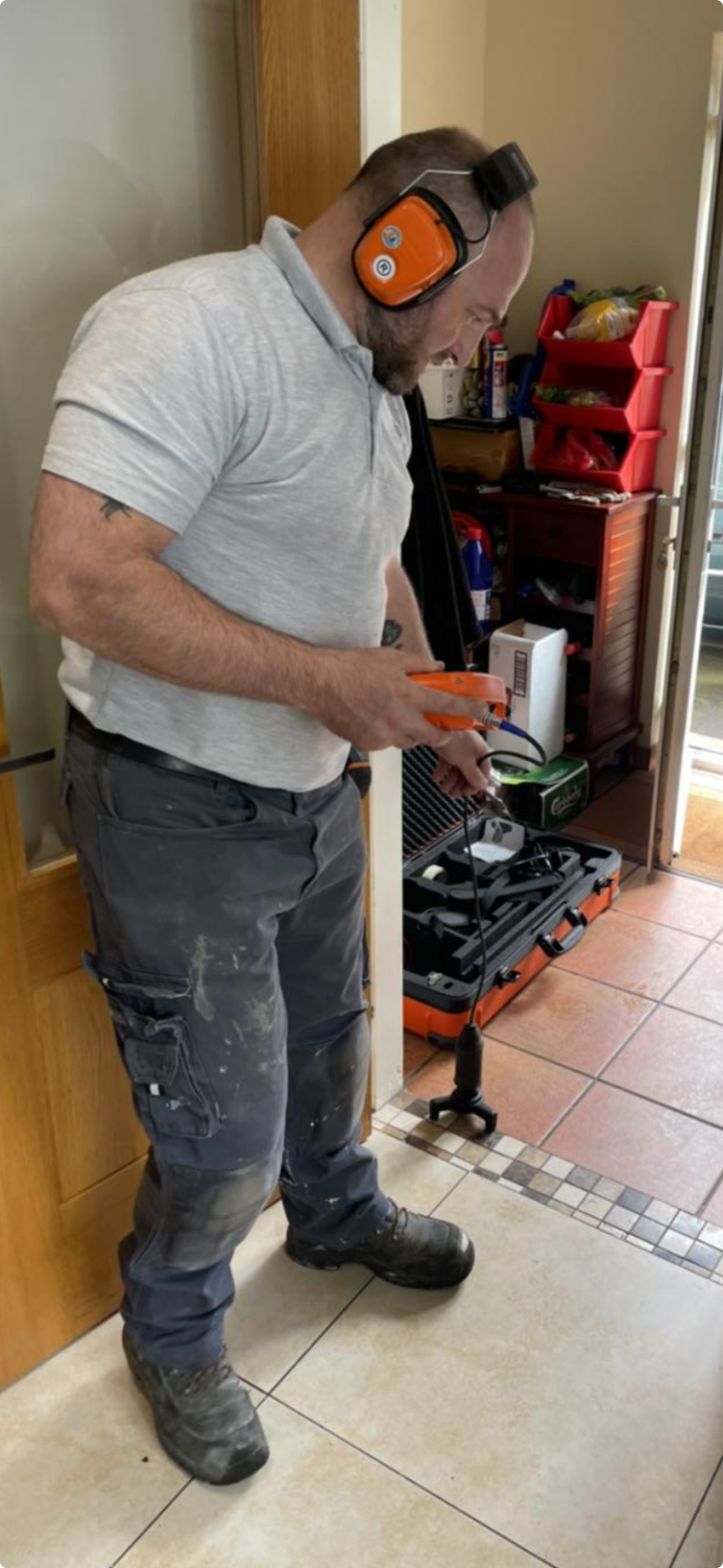 Technician performing electronic leak detection