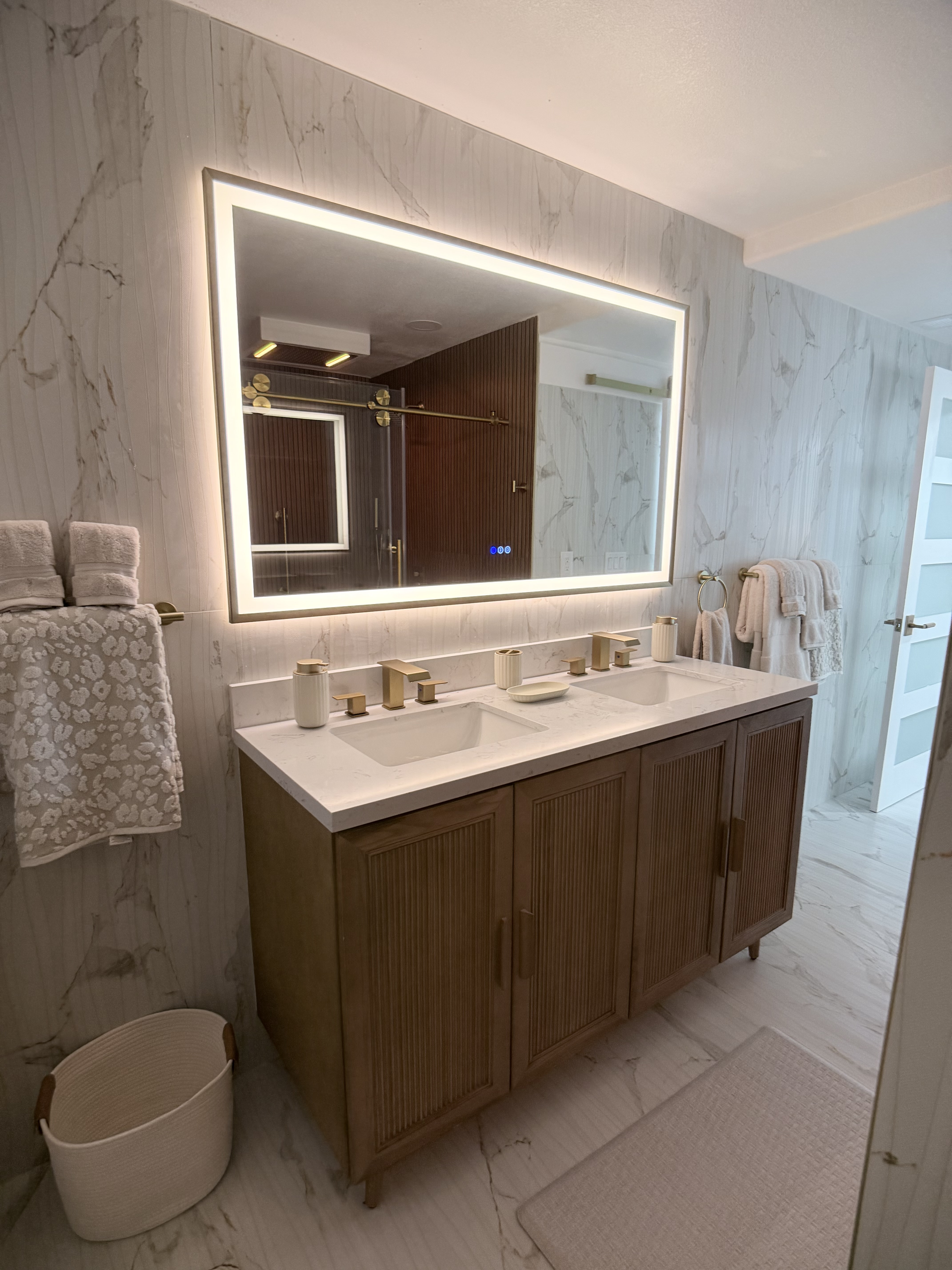 Luxury master bathroom — double vanity, LED mirror, marble walls