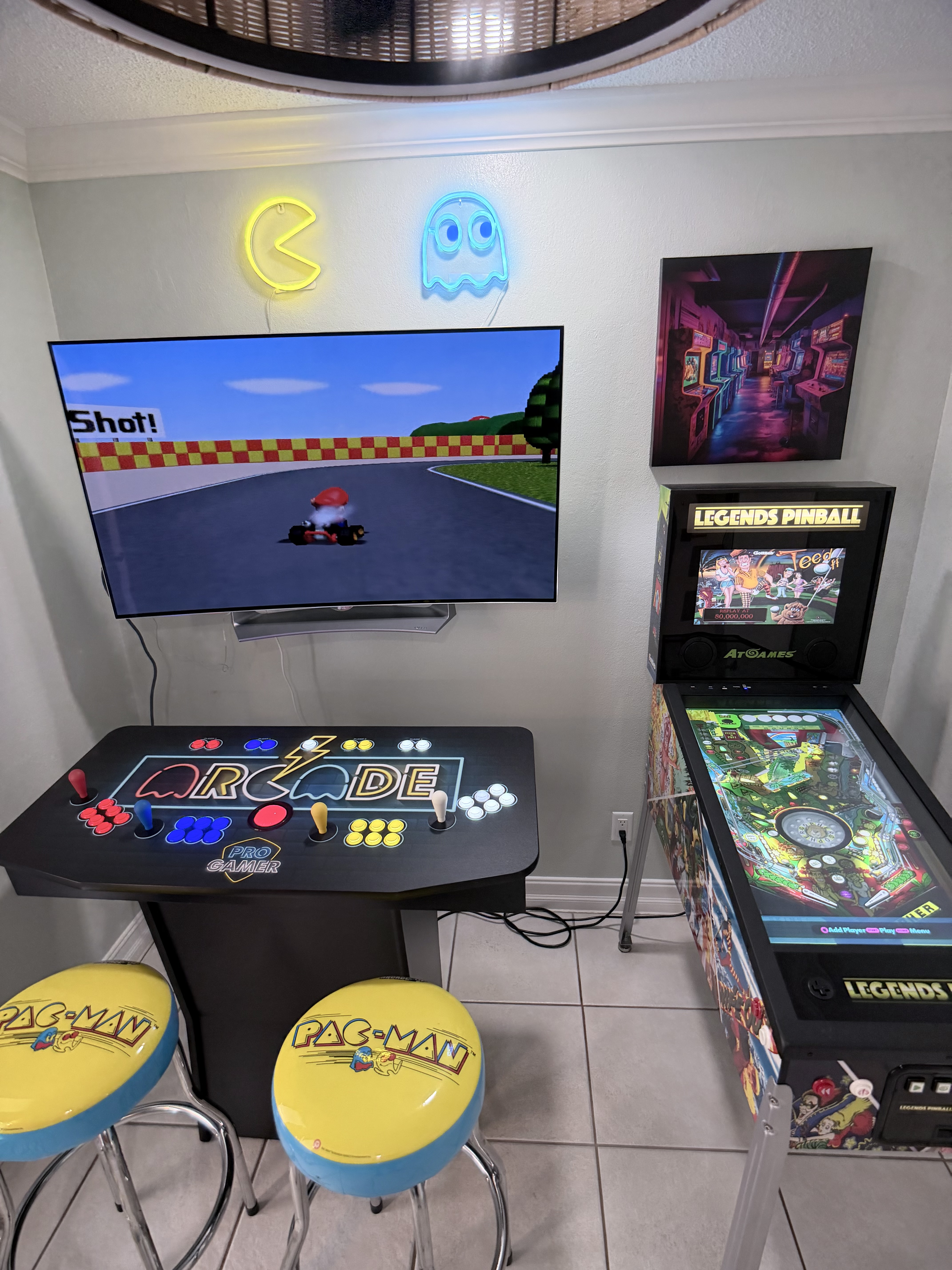 Game room with arcade, pinball, and Pac-Man stools