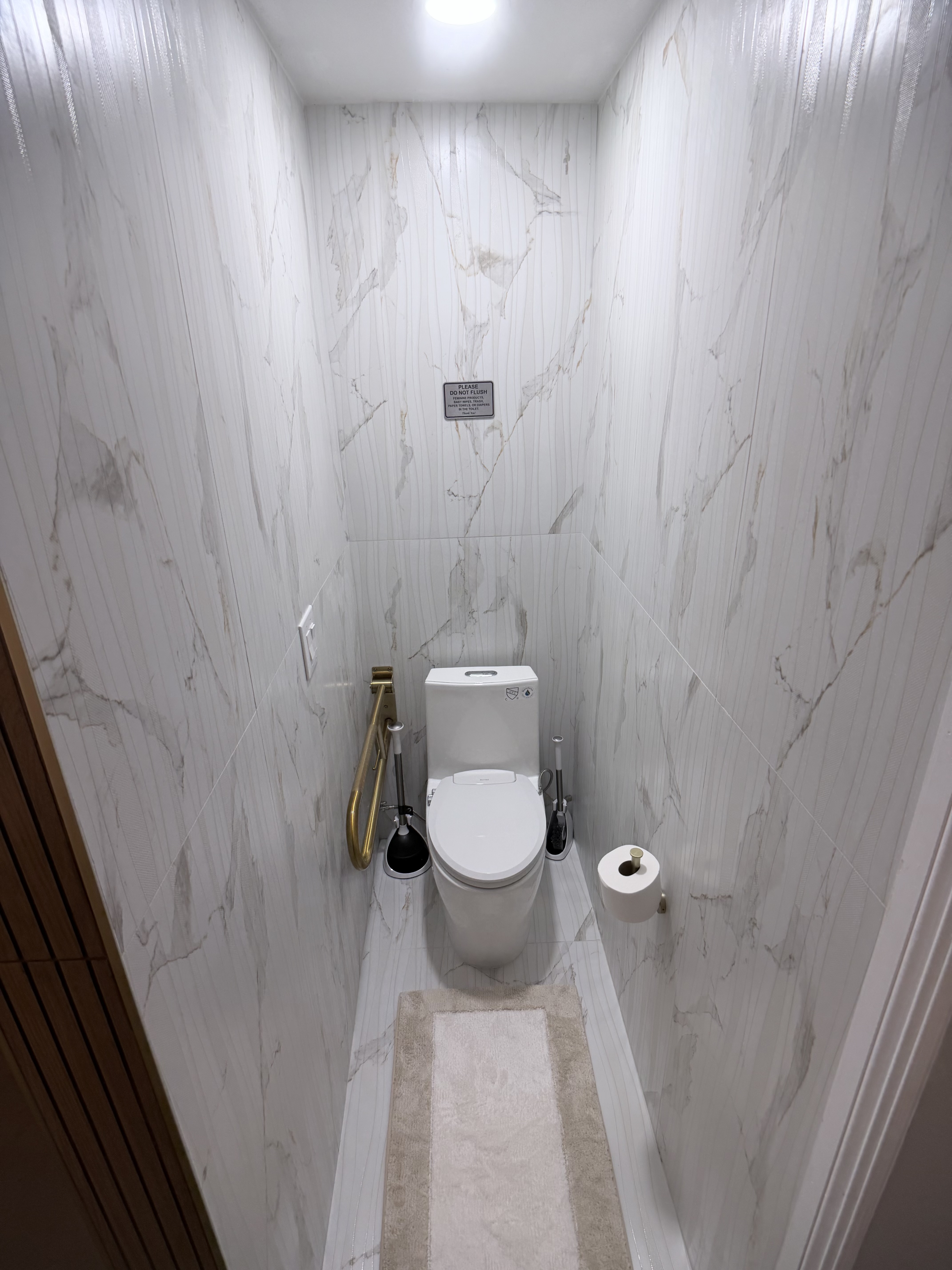 Walk-in spa shower with rain head, LED ceiling, wood slat wall and built-in bench